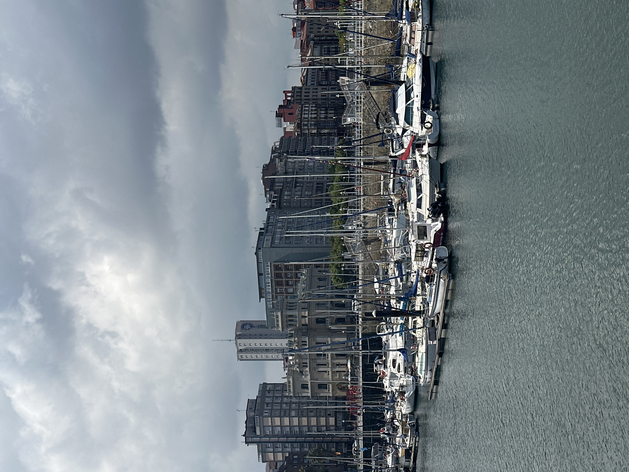 Gijón harbor and outdoor photo exhibition on a July morning