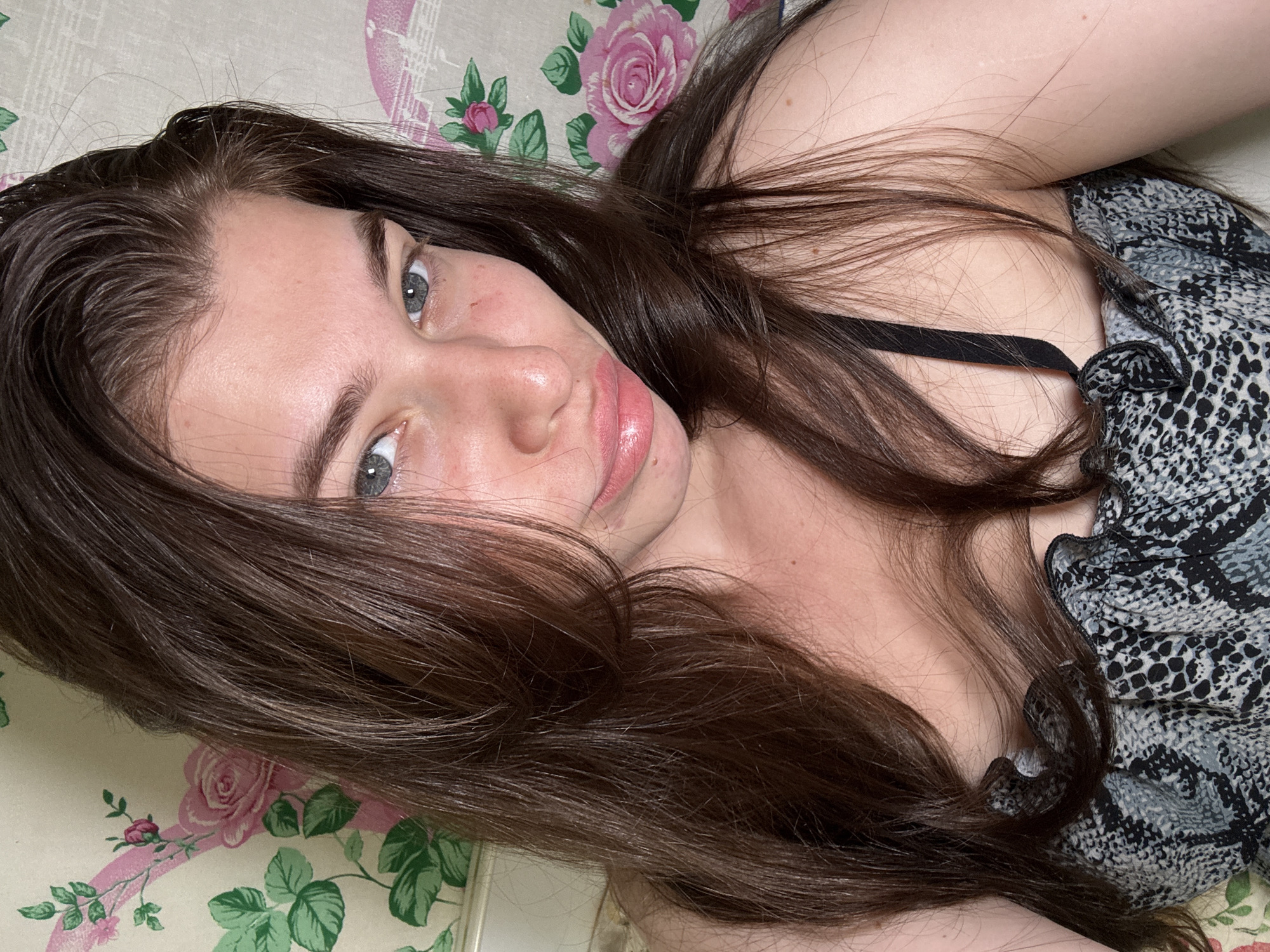 Woman rests on floral bedding in Мещёры, Russia