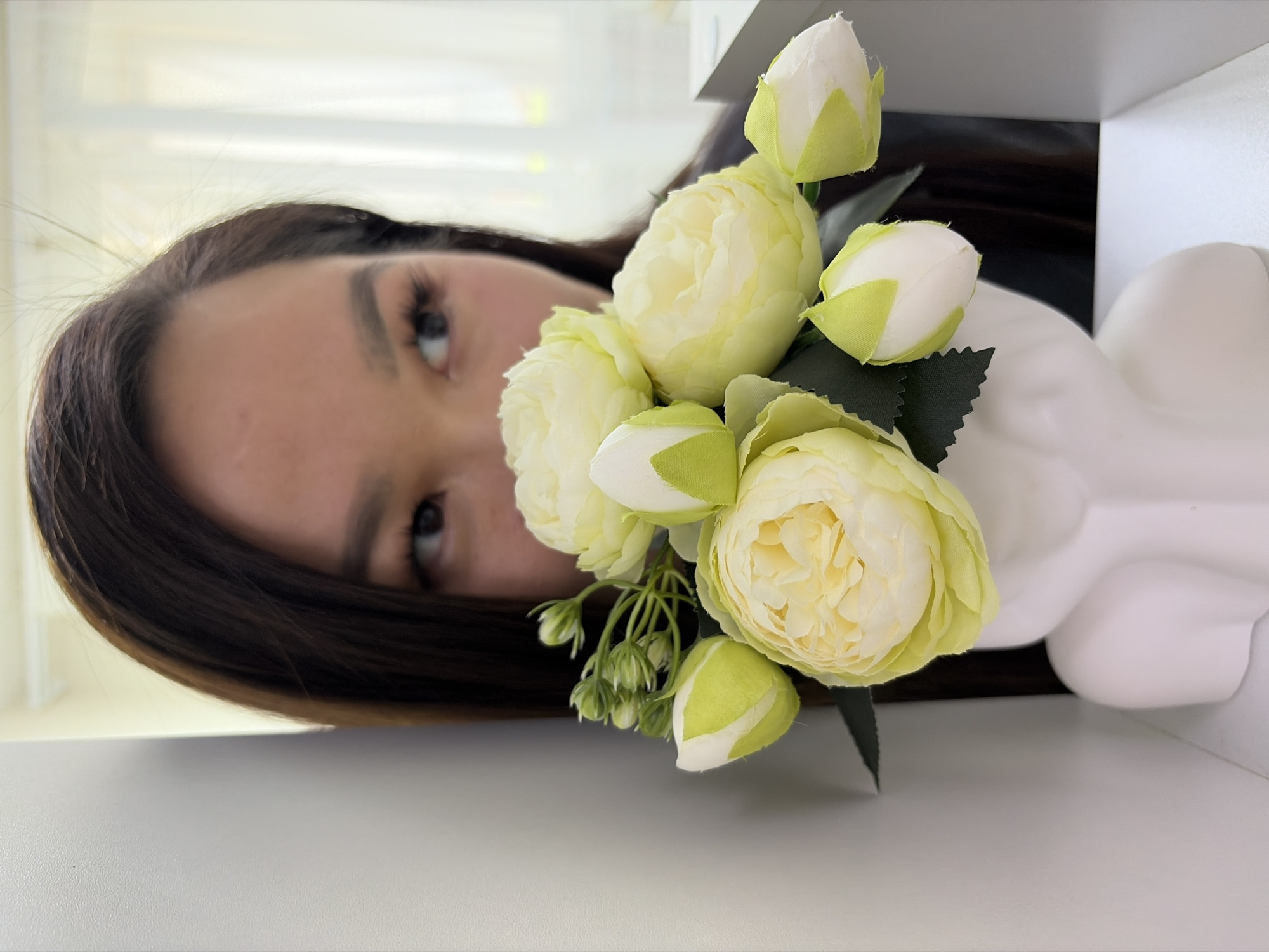Woman documented with flowers, chocolate, medical supplies indoors