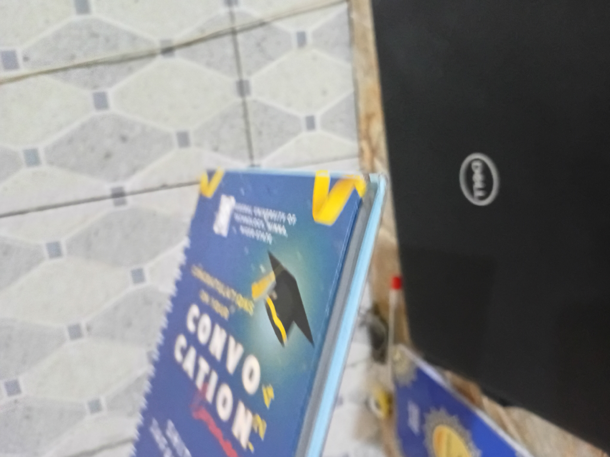 Graduation materials observed including convocation book and cap