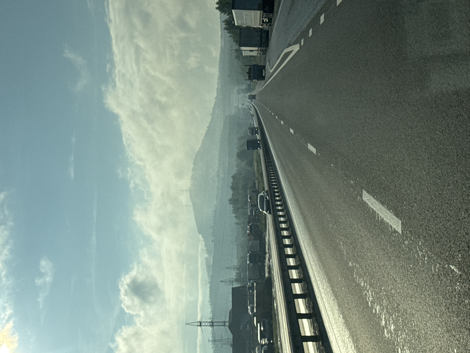 Hazy highway stretching through Revda under an overcast sky.