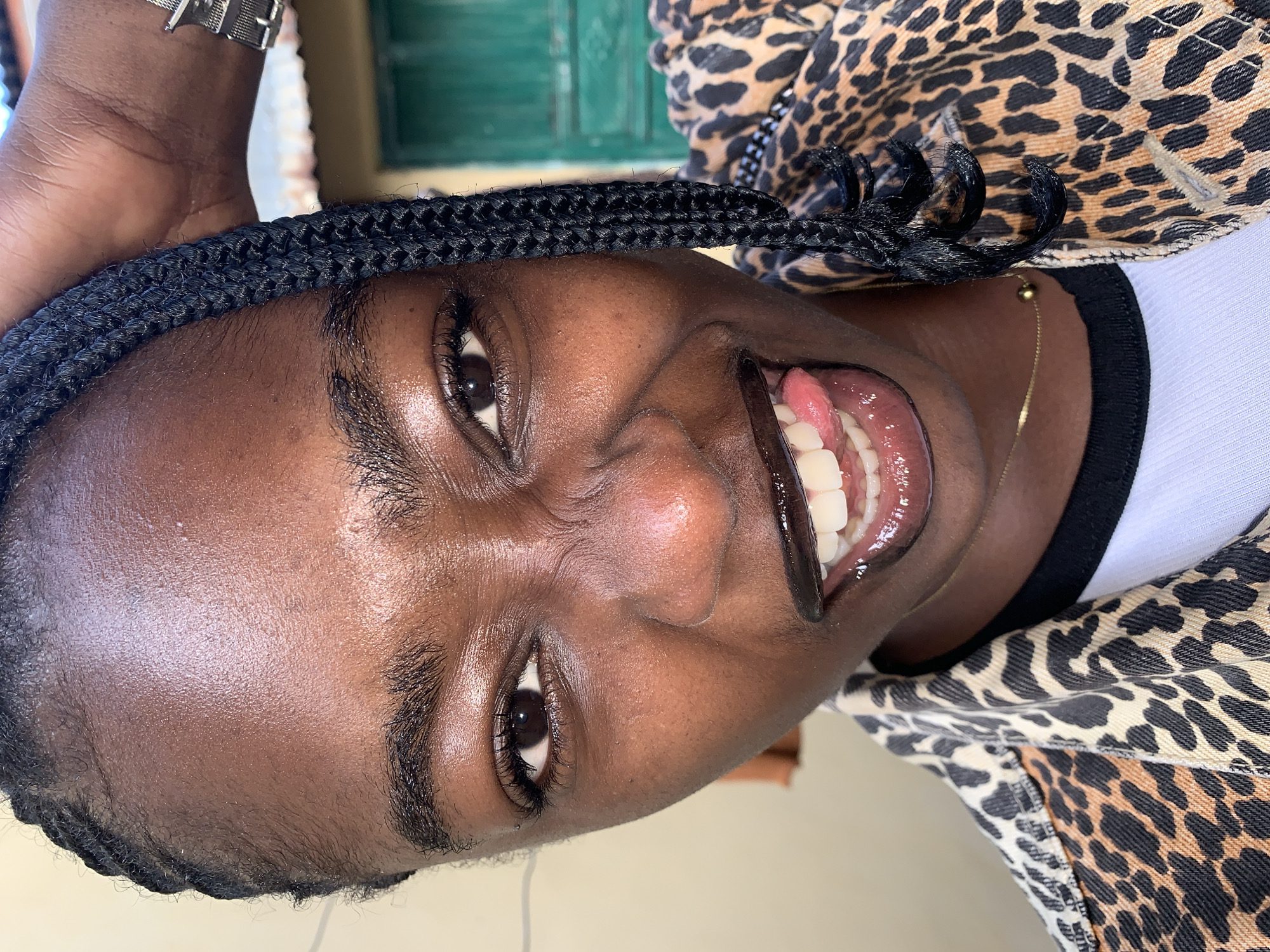 Selfie session in Rafin Par, Nigeria, leopard-print jacket and braids.
