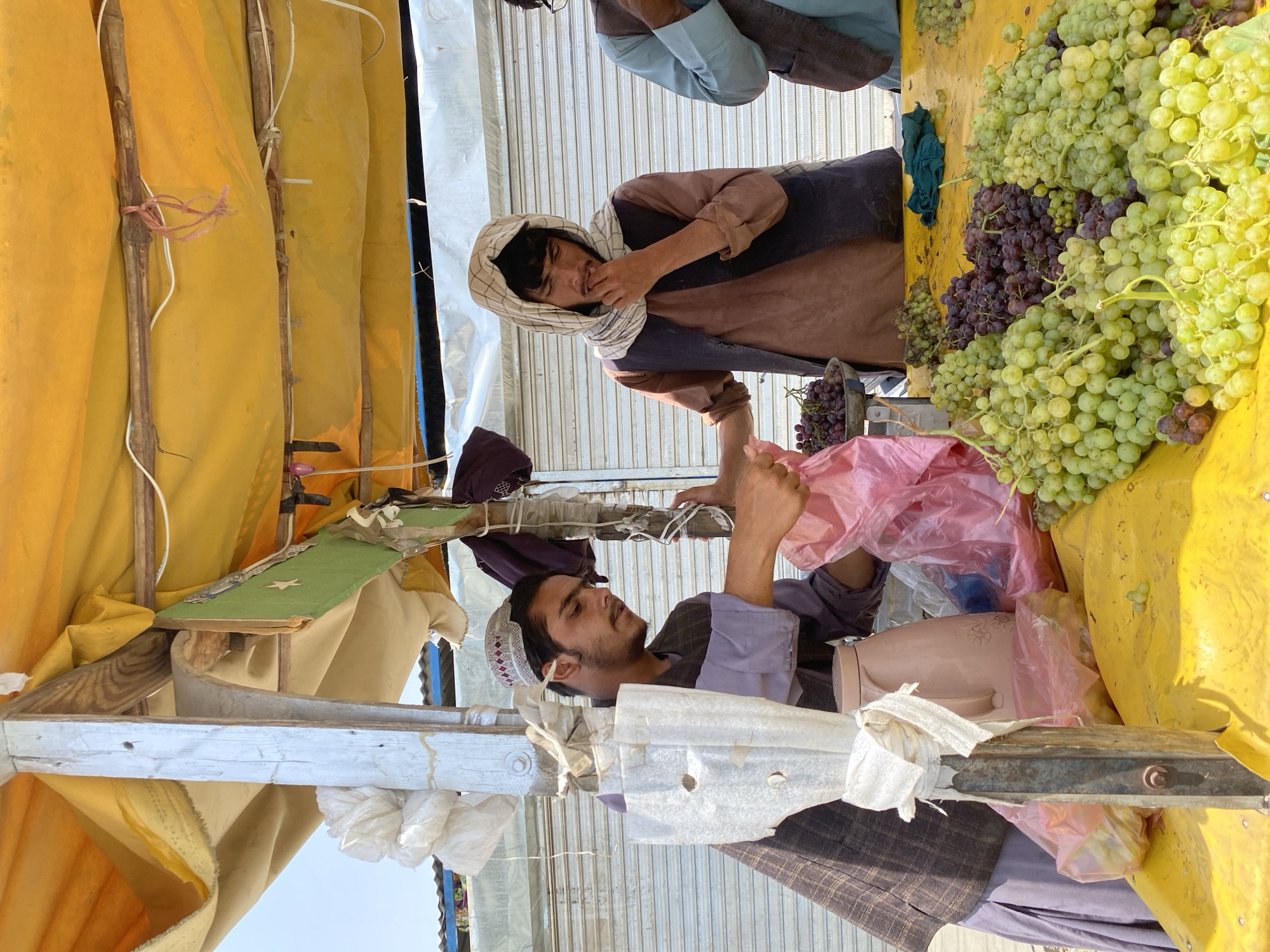 Street commerce and traffic moving through central Kandahar