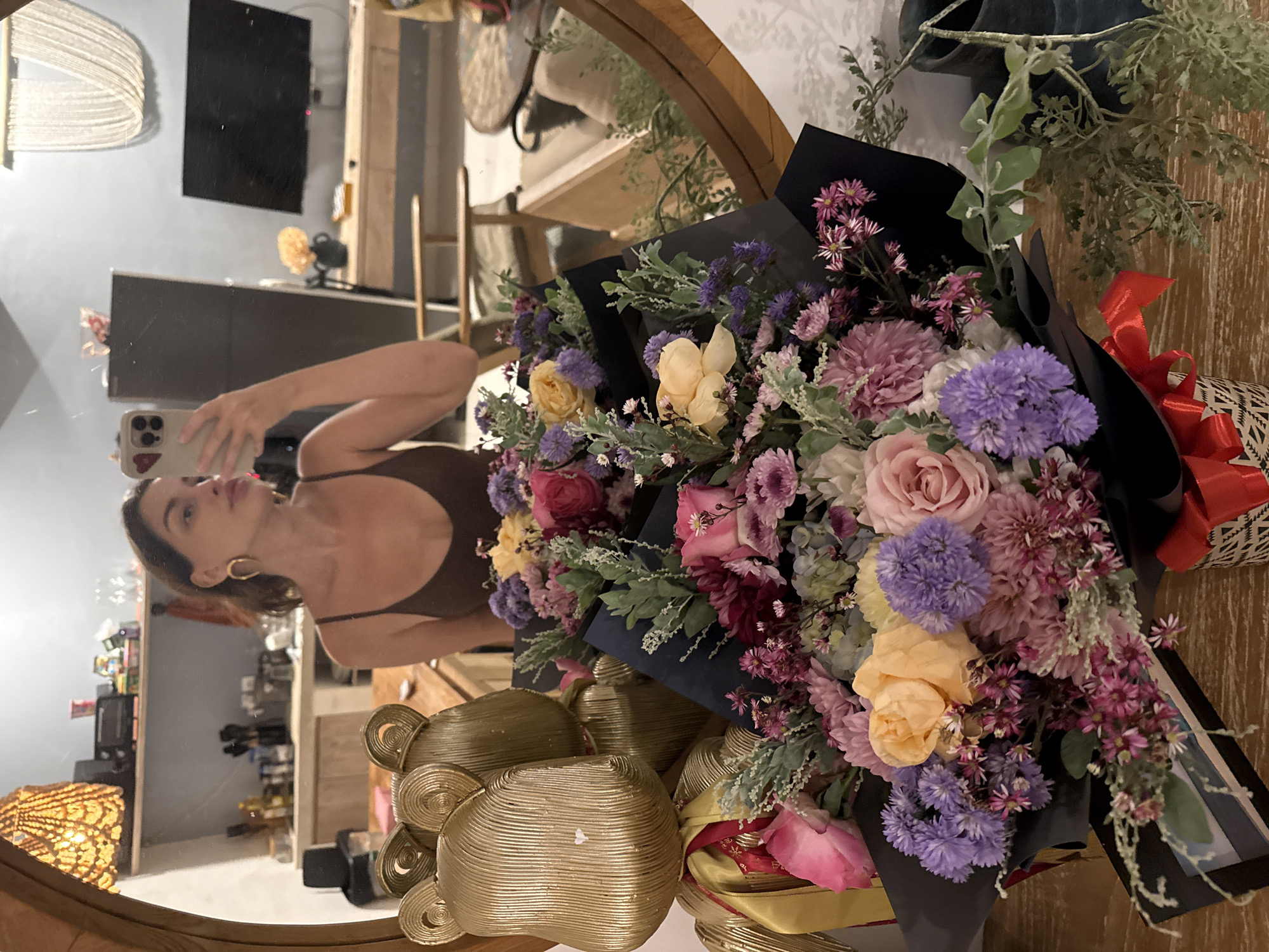 Woman takes selfie, flower bouquets photographed in North Kuta