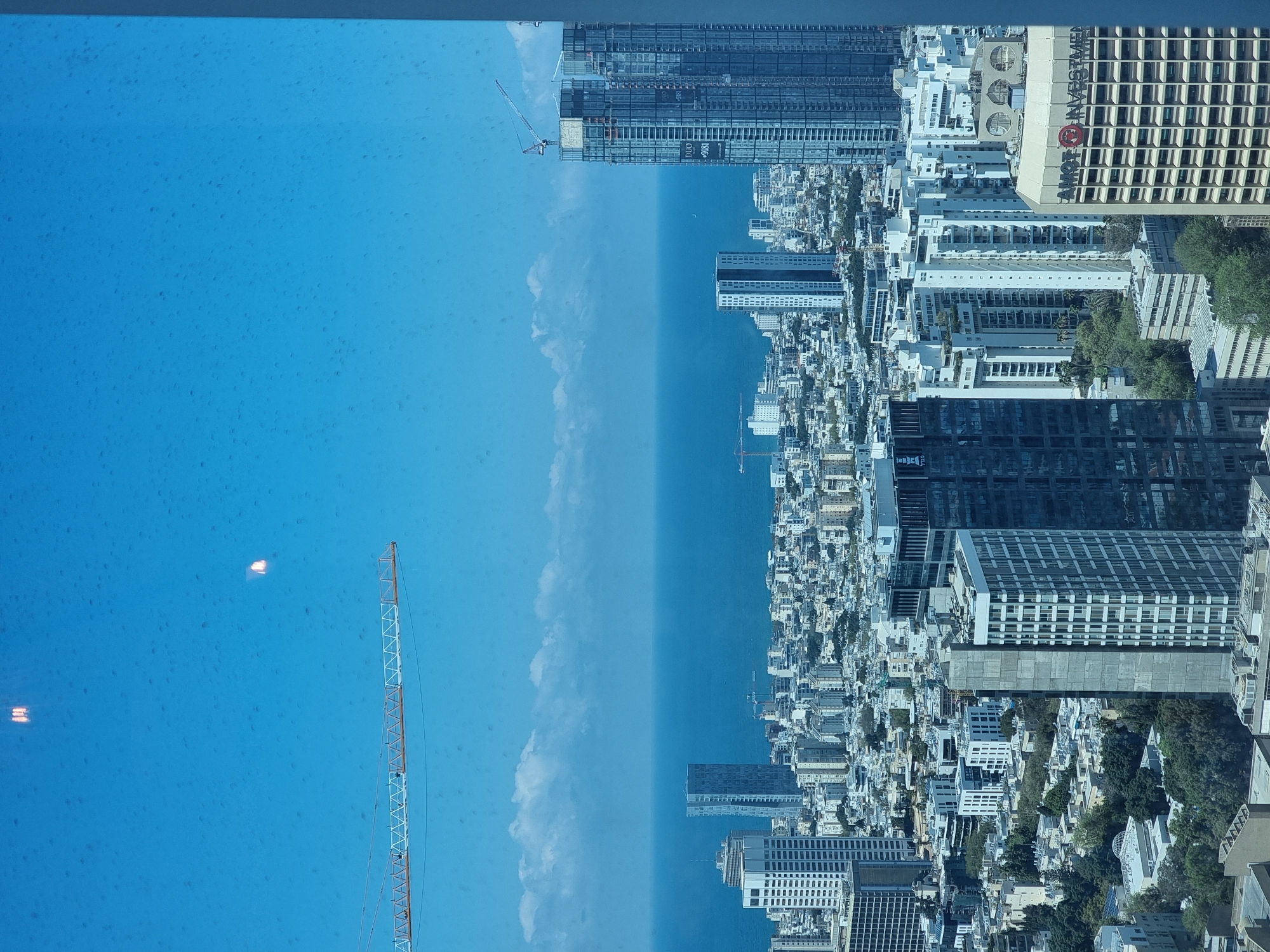 Window view of Tel Aviv cityscape captured Sunday morning