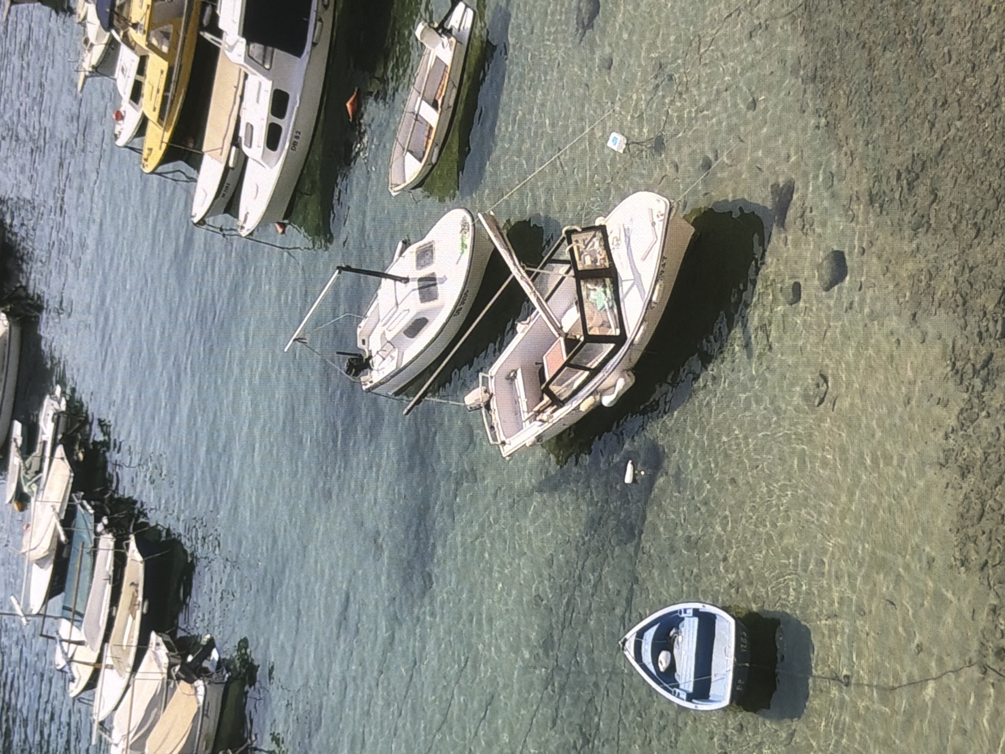 Boats in shallow water and a stone building facade