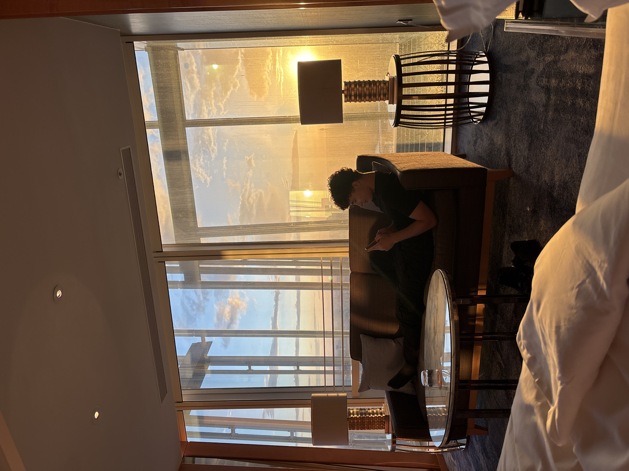 Man enjoys sunset in modern London hotel suite
