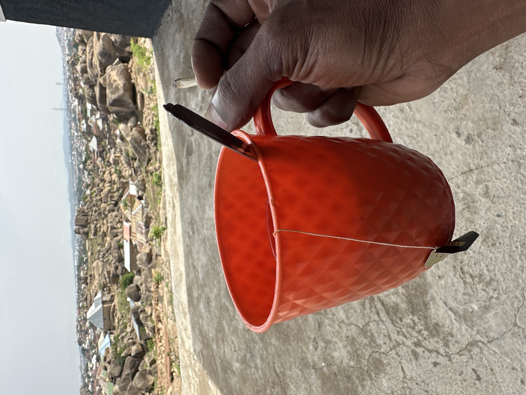 Morning coffee break captured against Jos Nigeria's rocky cityscape