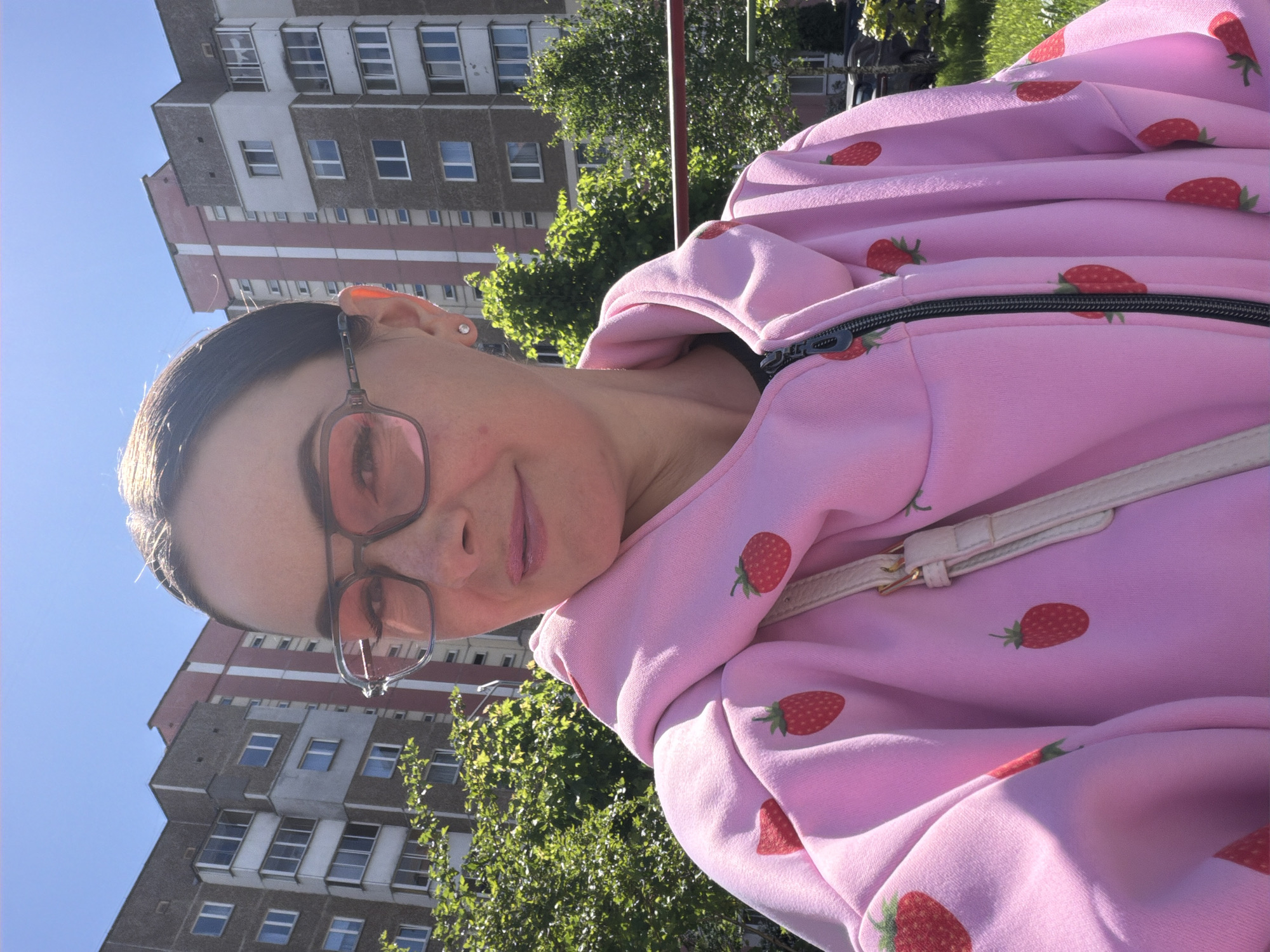 Woman in strawberry hoodie spotted in urban park area