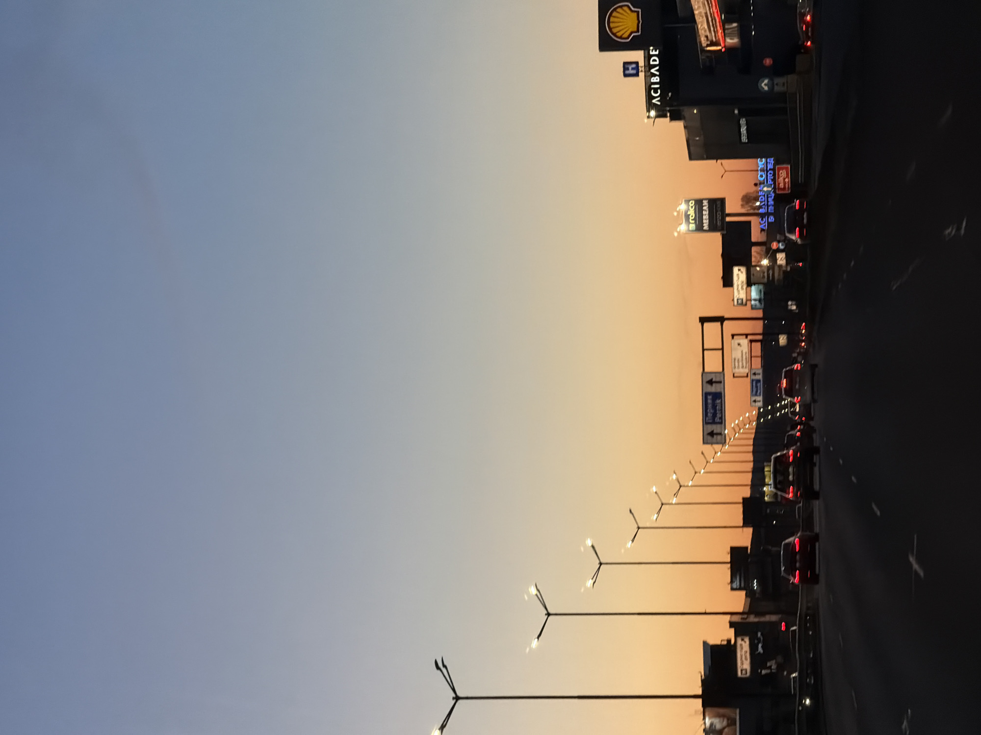 Evening traffic flows past Shell station on Sofia highway