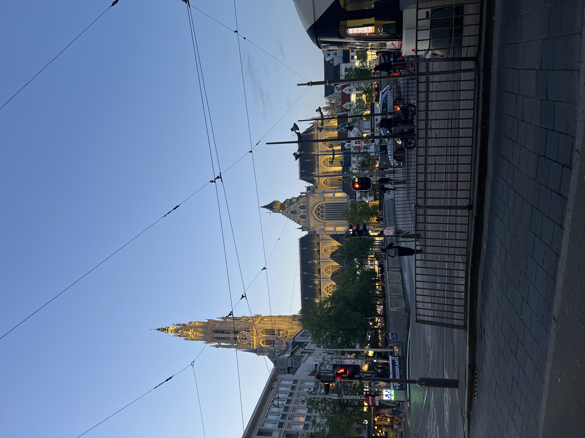 Clear twilight sky illuminates Antwerp cityscape during evening hours