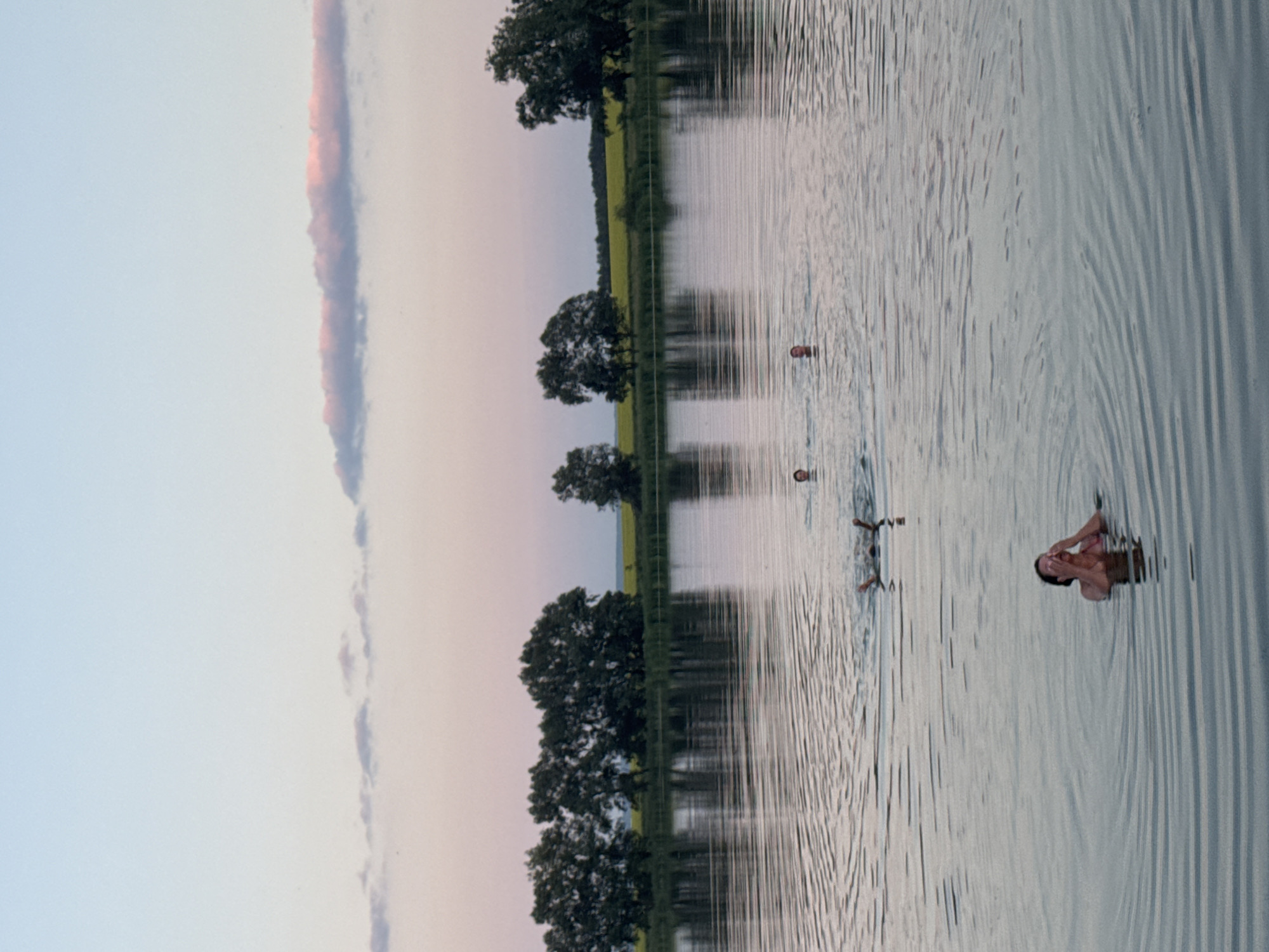Evening swim at a quiet lake as dusk settles in