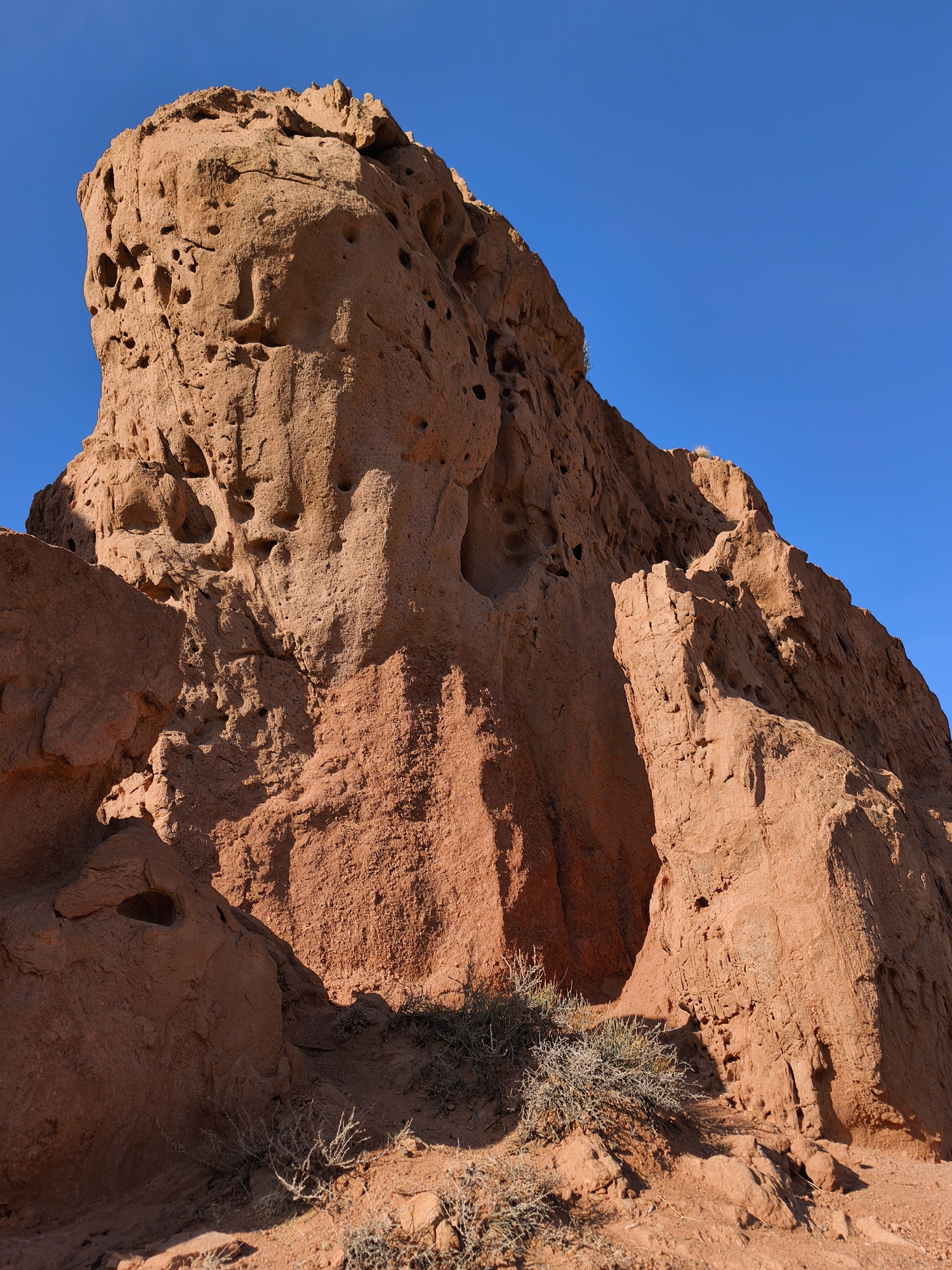 Tourist explores dramatic red rock canyon in Kyrgyzstan