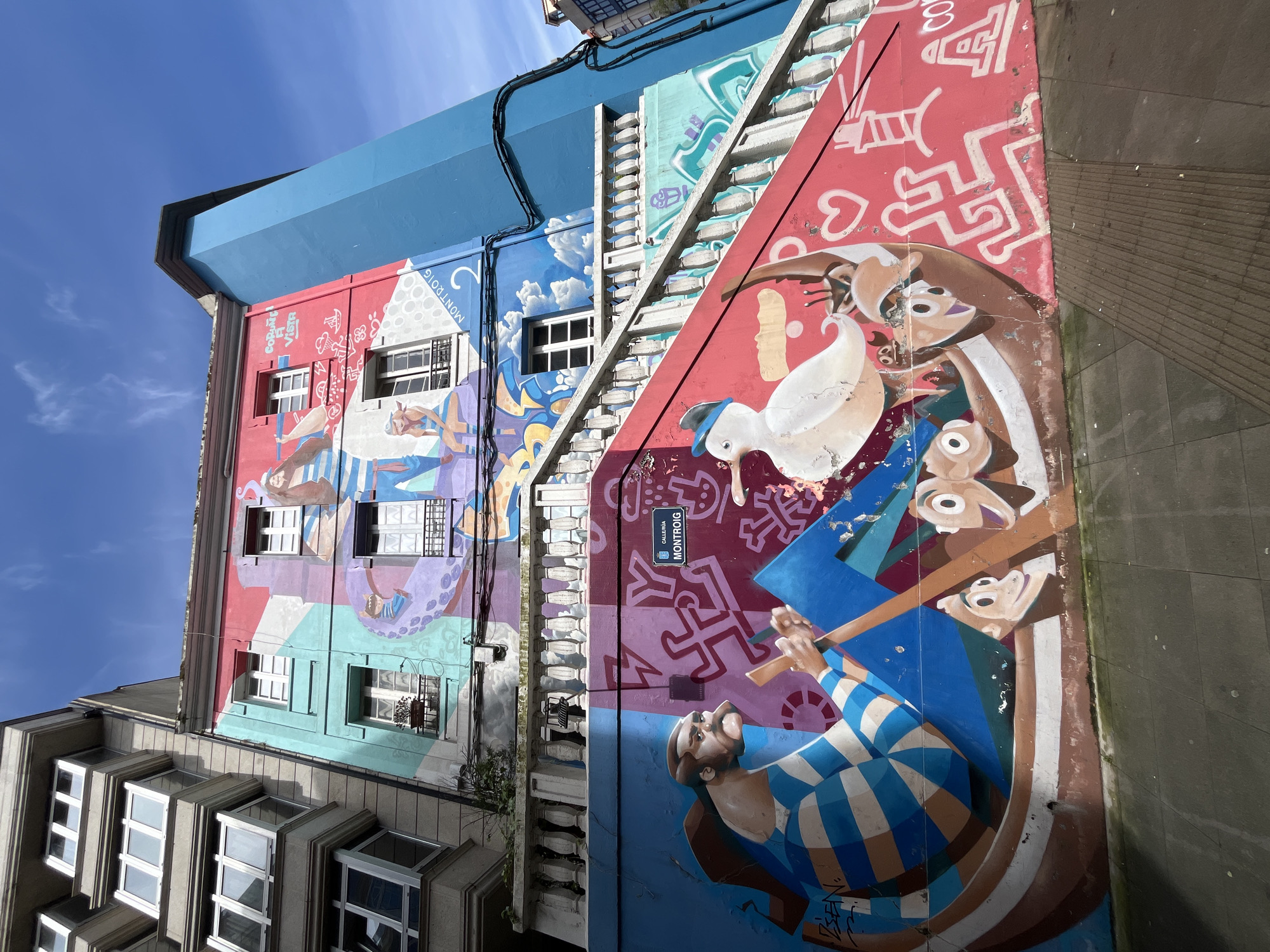 Colorful murals observed on tall building in A Coruña