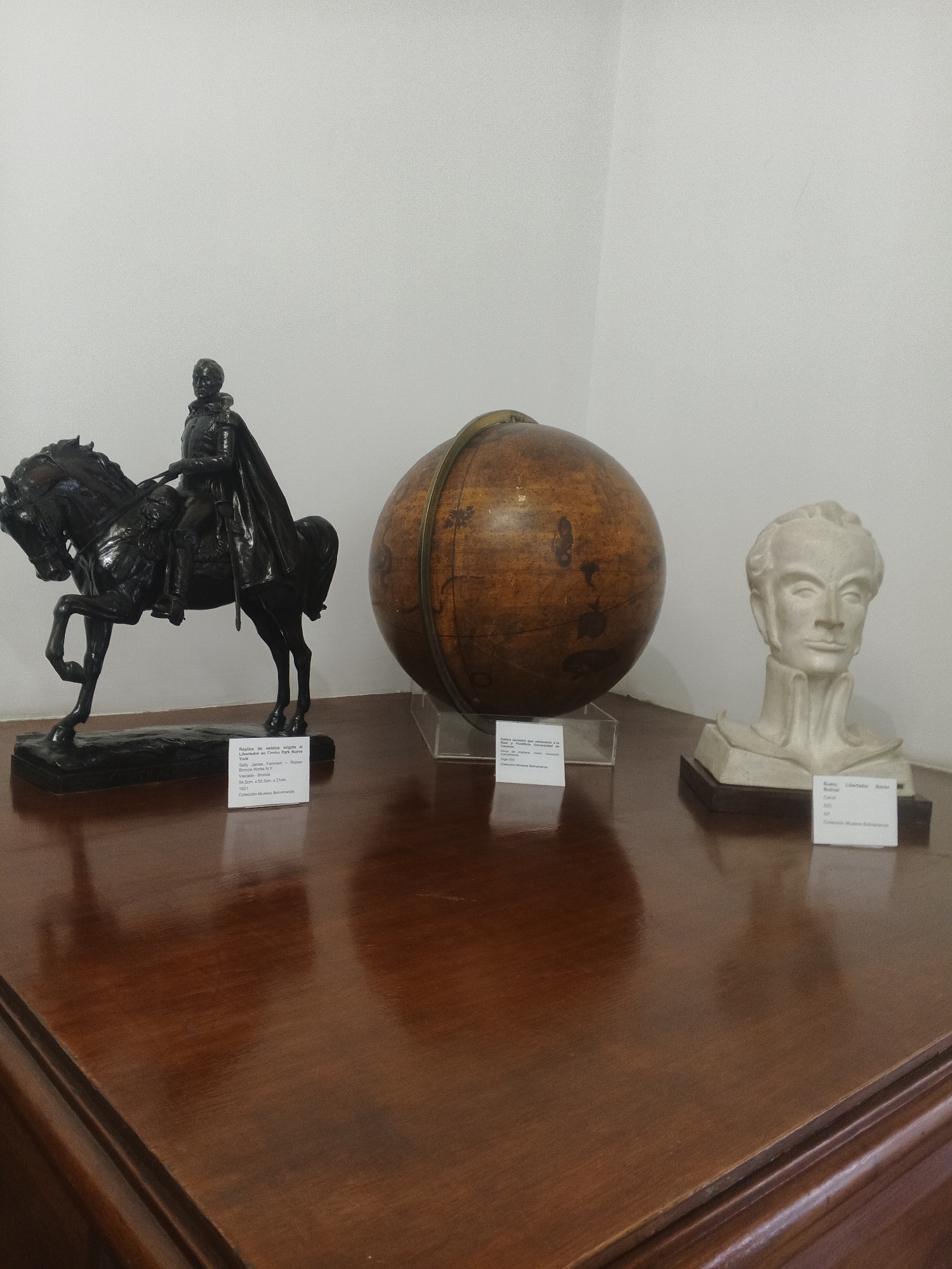 Museum visitor documents Venezuelan history exhibits and umbrella street