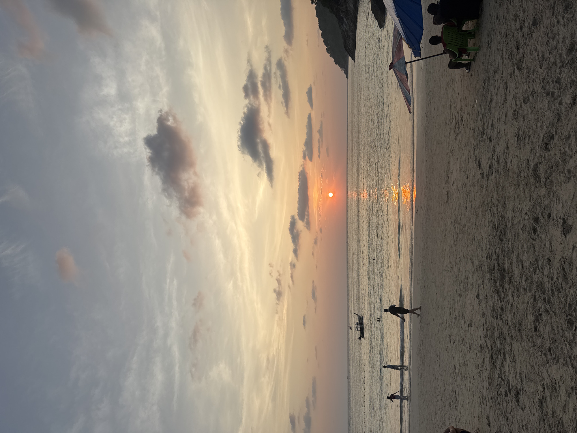 Tourists enjoy sunset hours at busy Patong Beach, Thailand