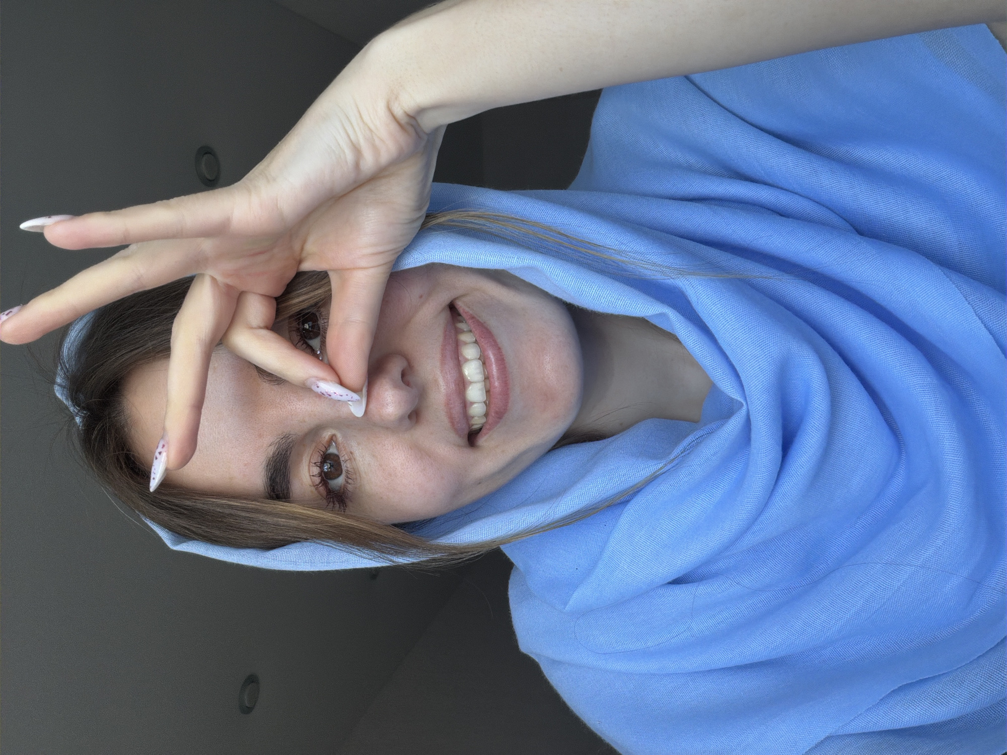 Woman in blue headscarf captured in morning moments, Sarapul