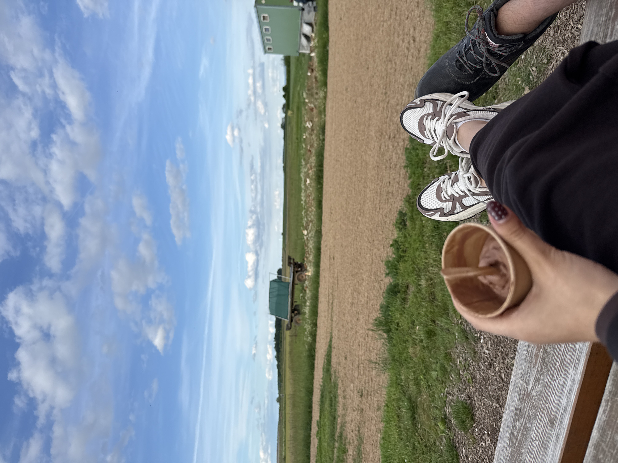 Two people share bench moment in Bruchköbel landscape