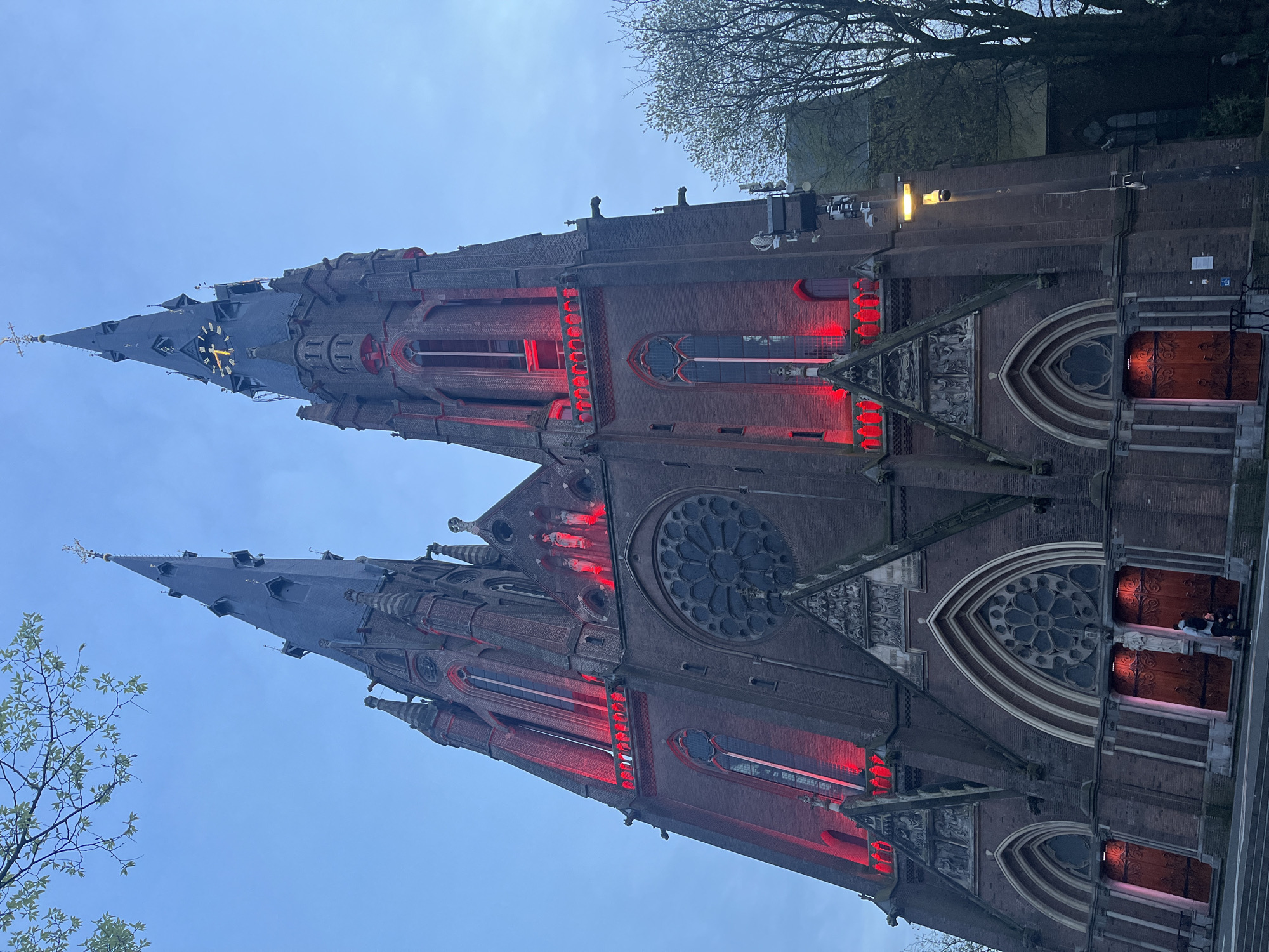 Gothic church illuminated red in Eindhoven evening