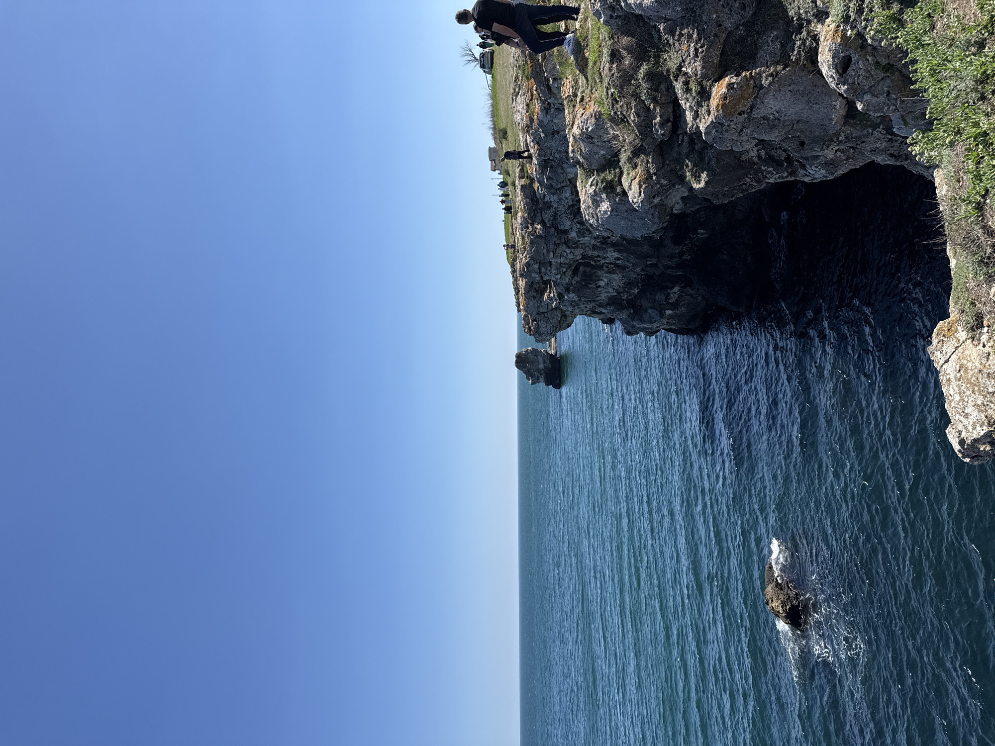 People gather on coastal cliffs in Tyulenovo, Bulgaria