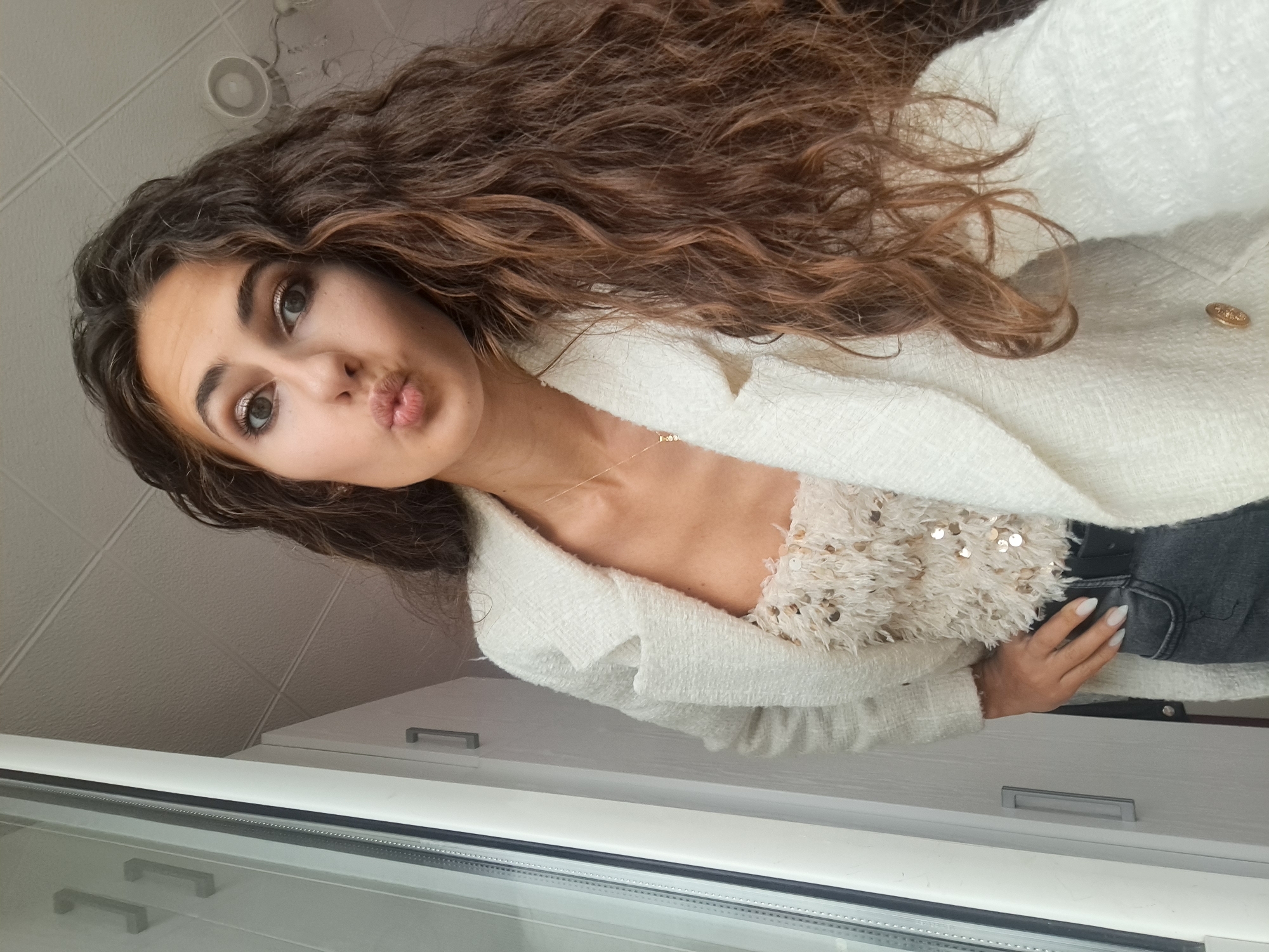 Woman takes selfies in white sequined outfits, Negovan Bulgaria