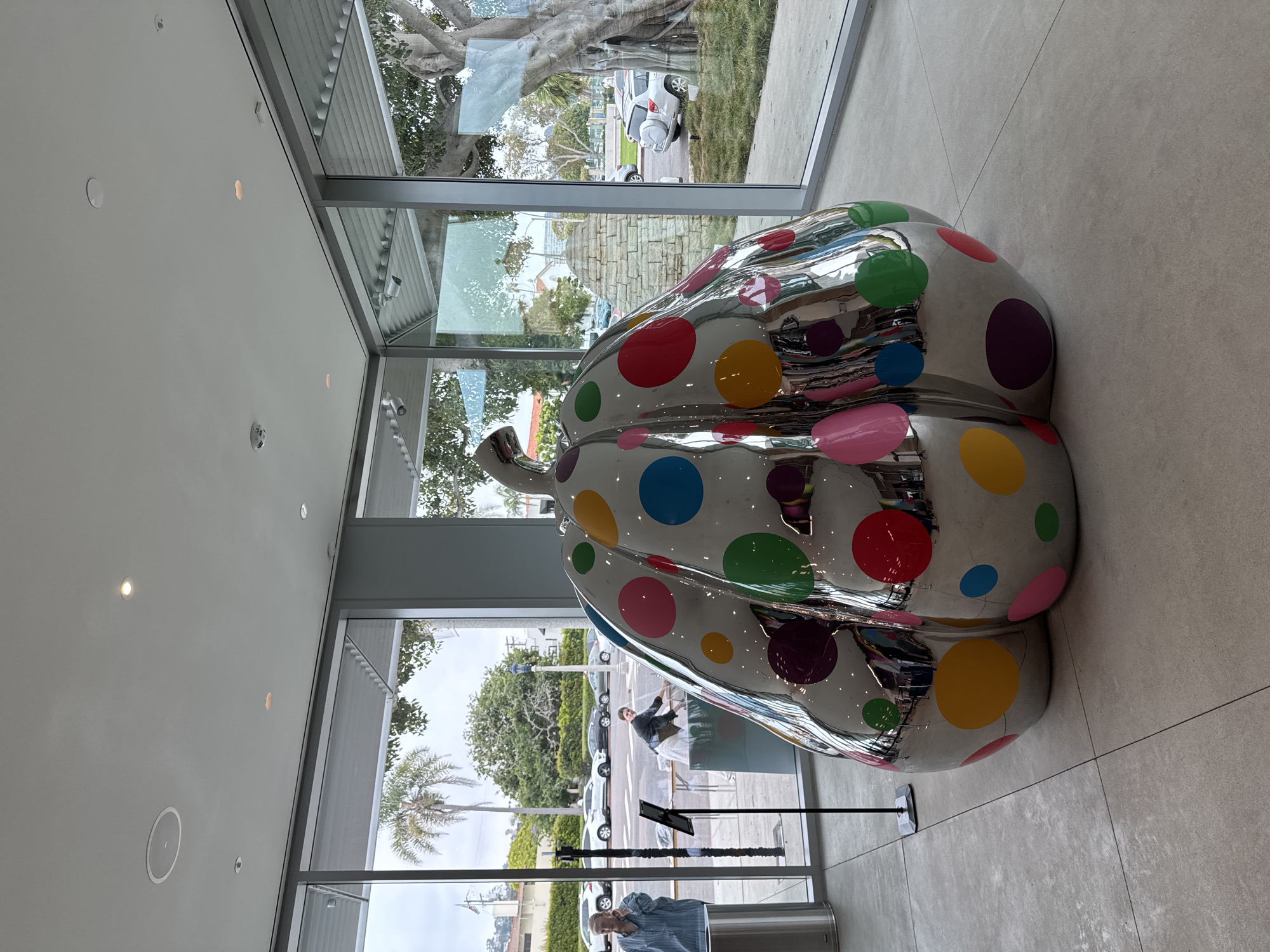 Woman and dachshund tour San Diego art museum evening