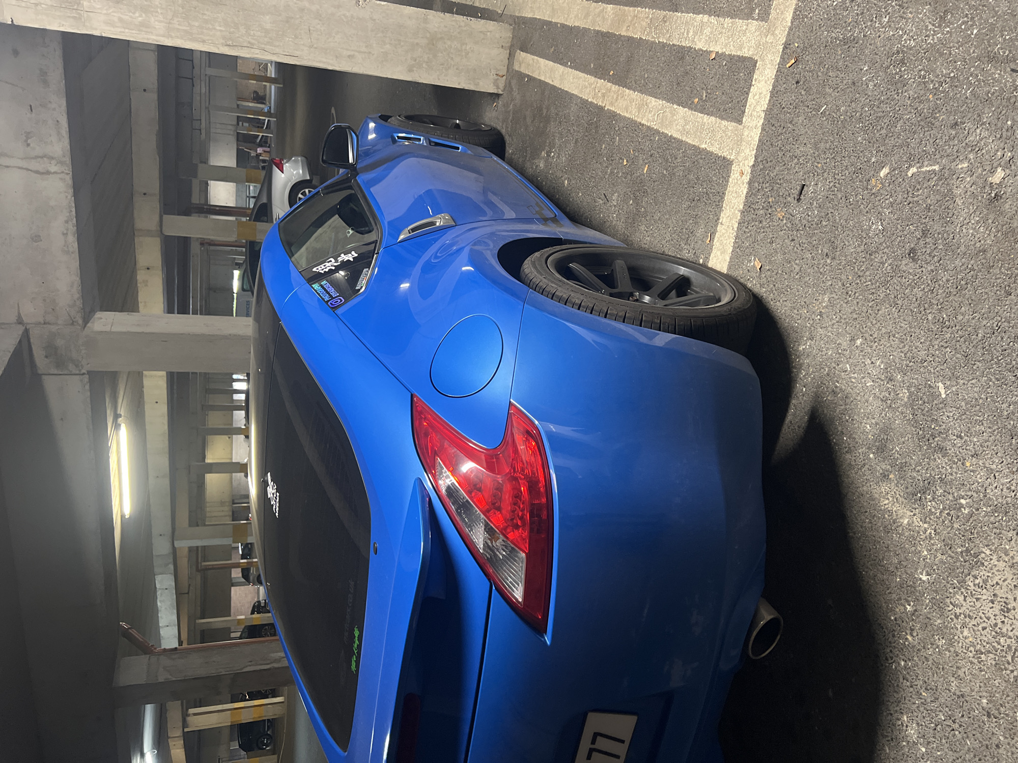 Vehicles spotted in underground parking garage during midday