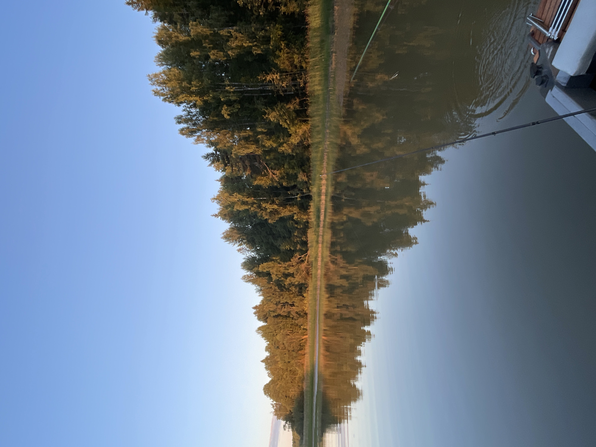 Fishing from a motorboat at sunset on a Russian lake