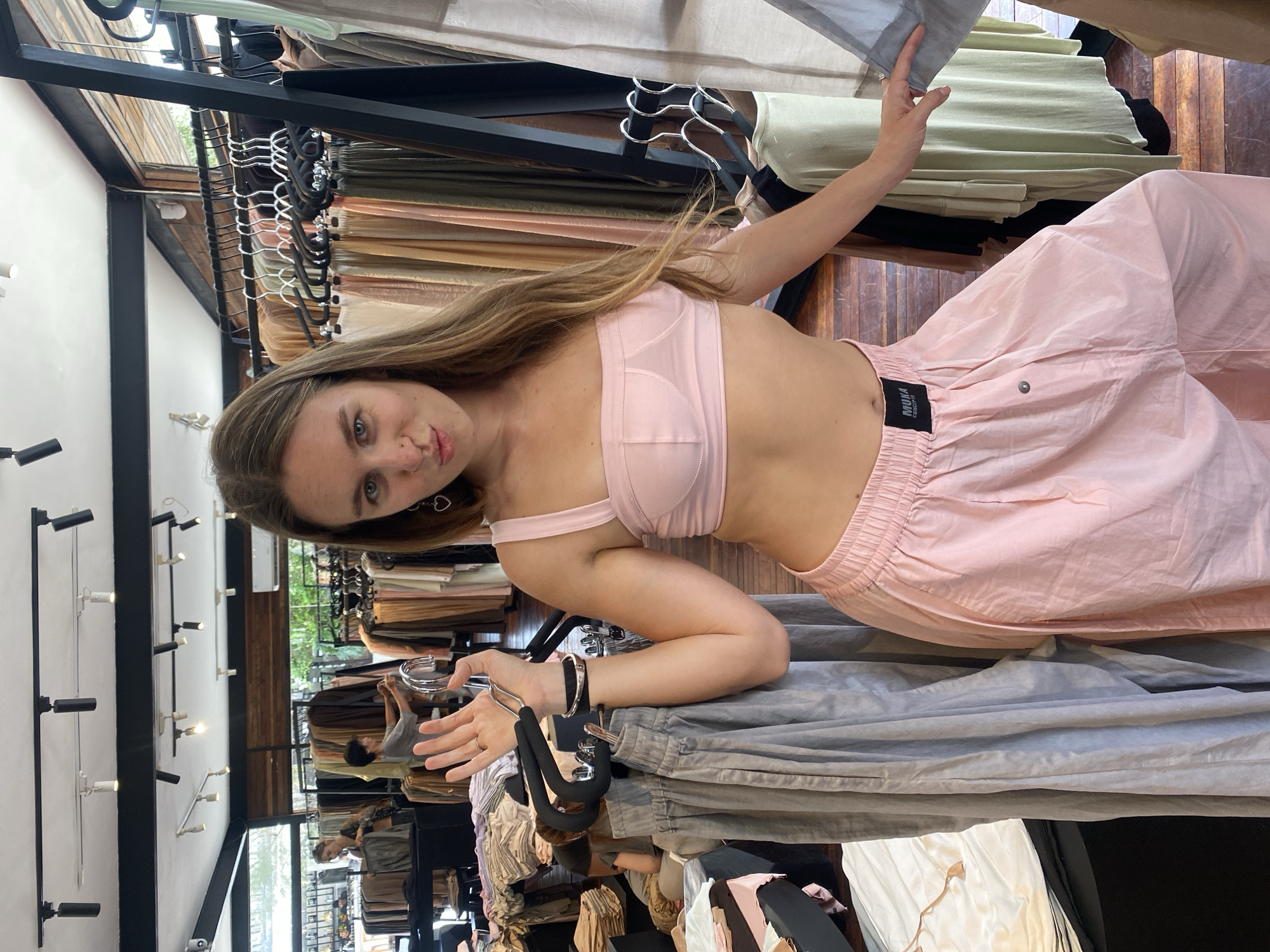Inside a Mengwi clothing boutique, browsing and trying on looks