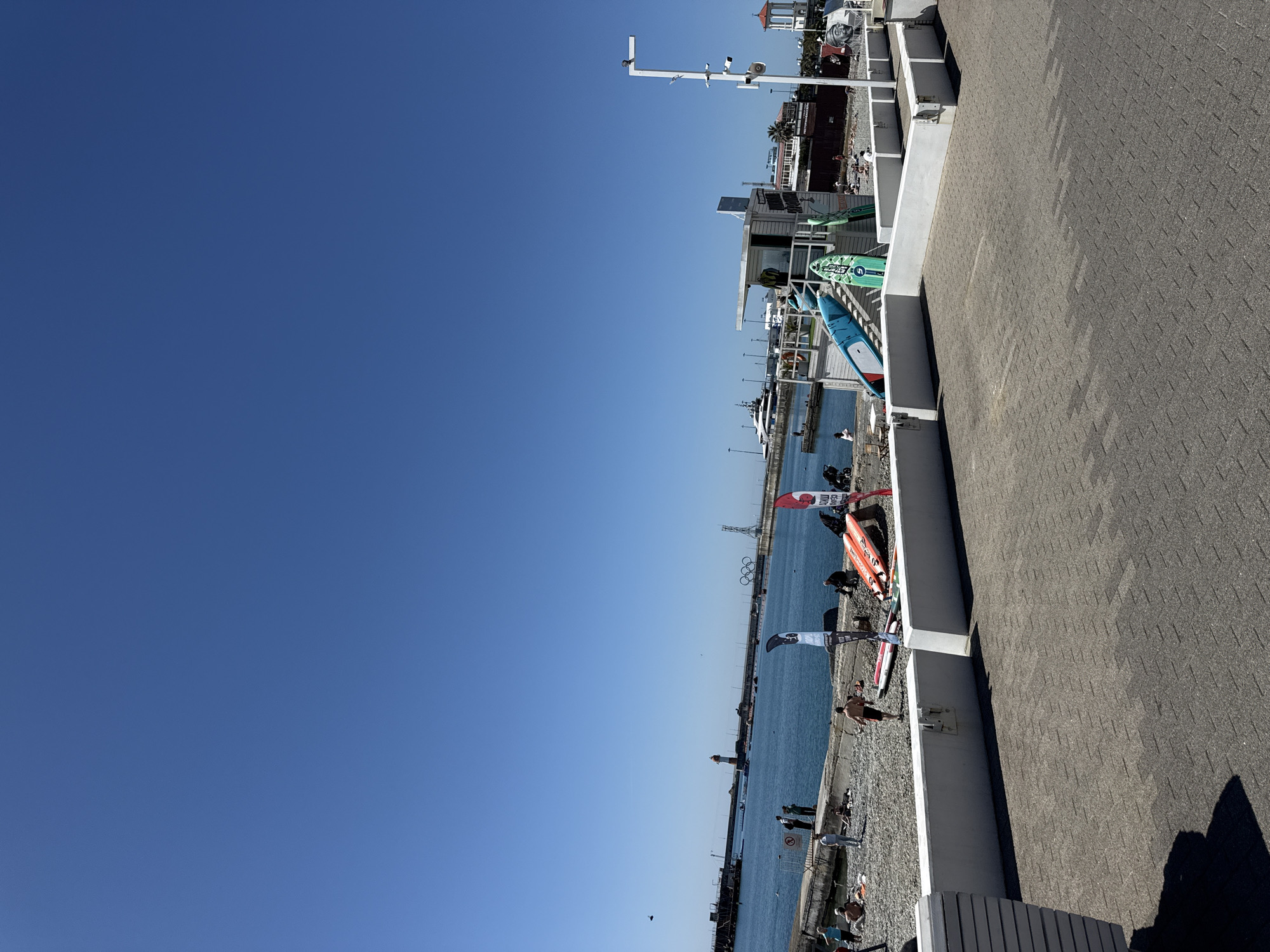 Sunny morning stroll through waterfront recreation area with carousel