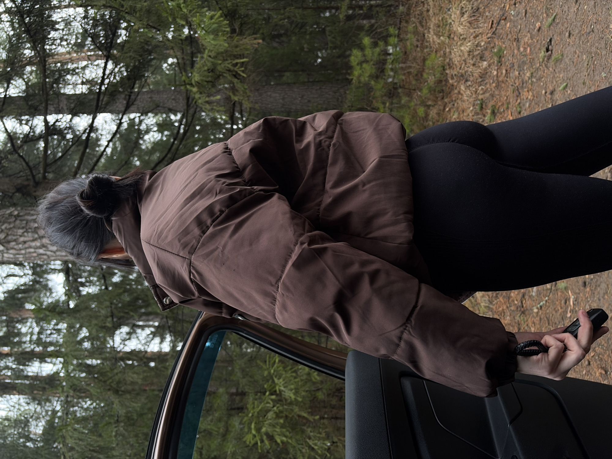 Woman documented near vehicle in wooded area outside Chaikovsky
