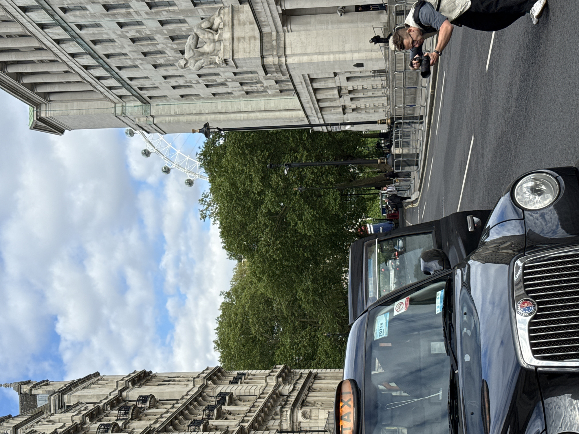 Photographer captures images beside London taxi near London Eye