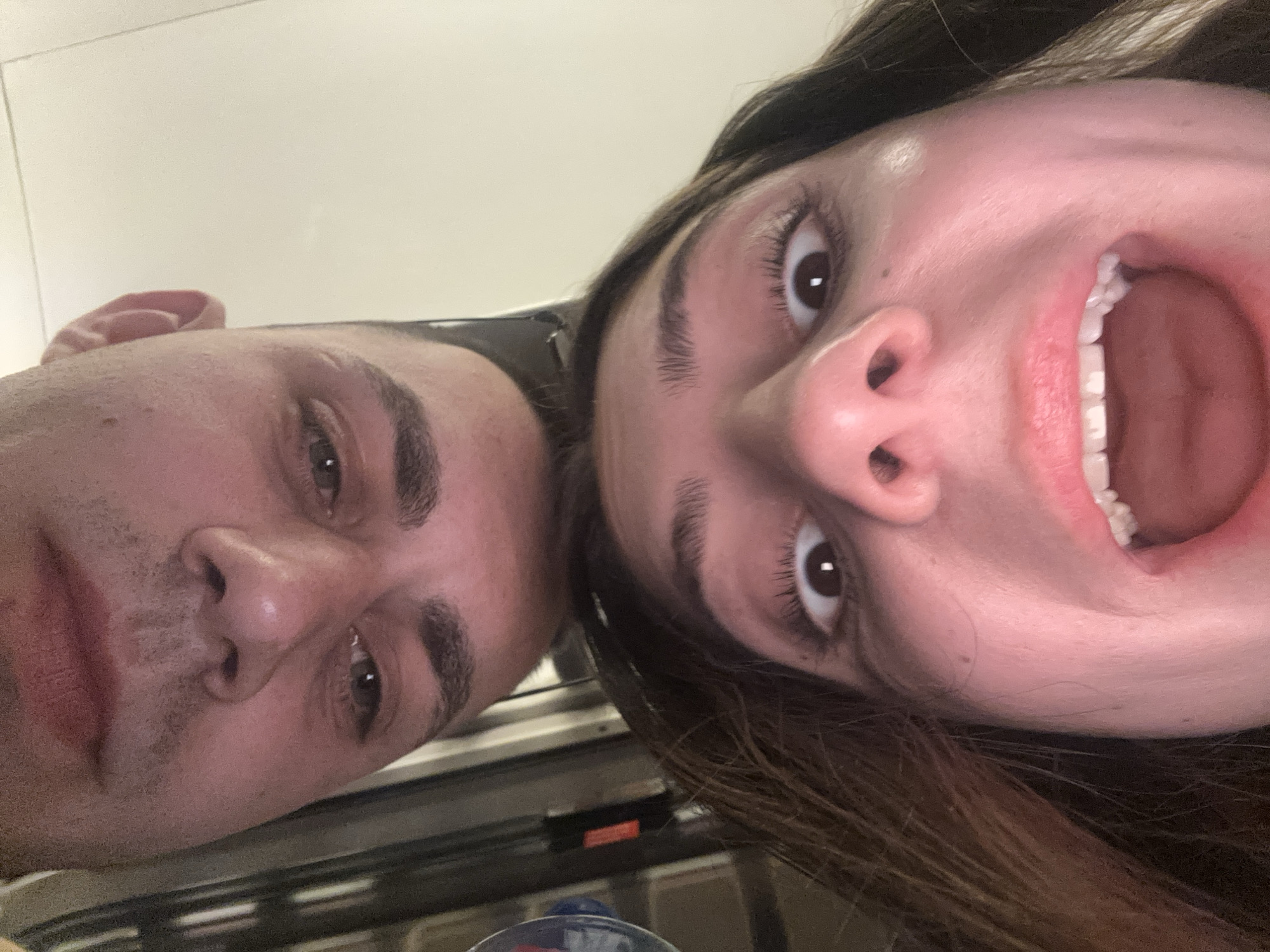 Couple takes selfies together in brief photo session