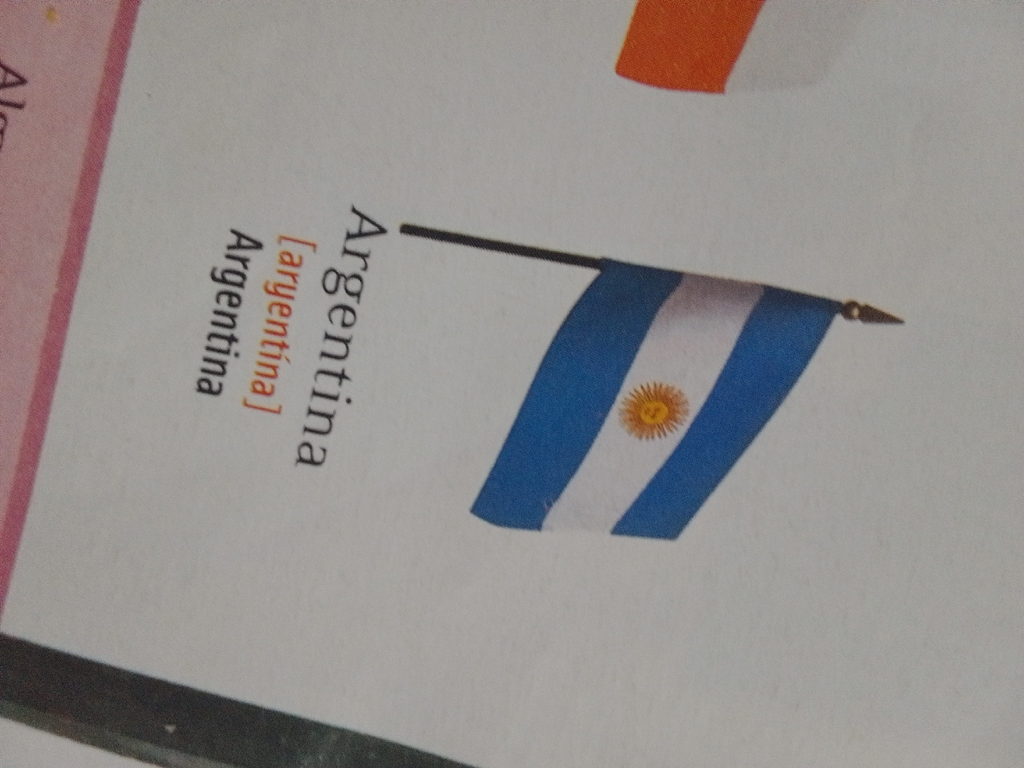 Toy cars and country flags laid out on striped fabric in Venezuela