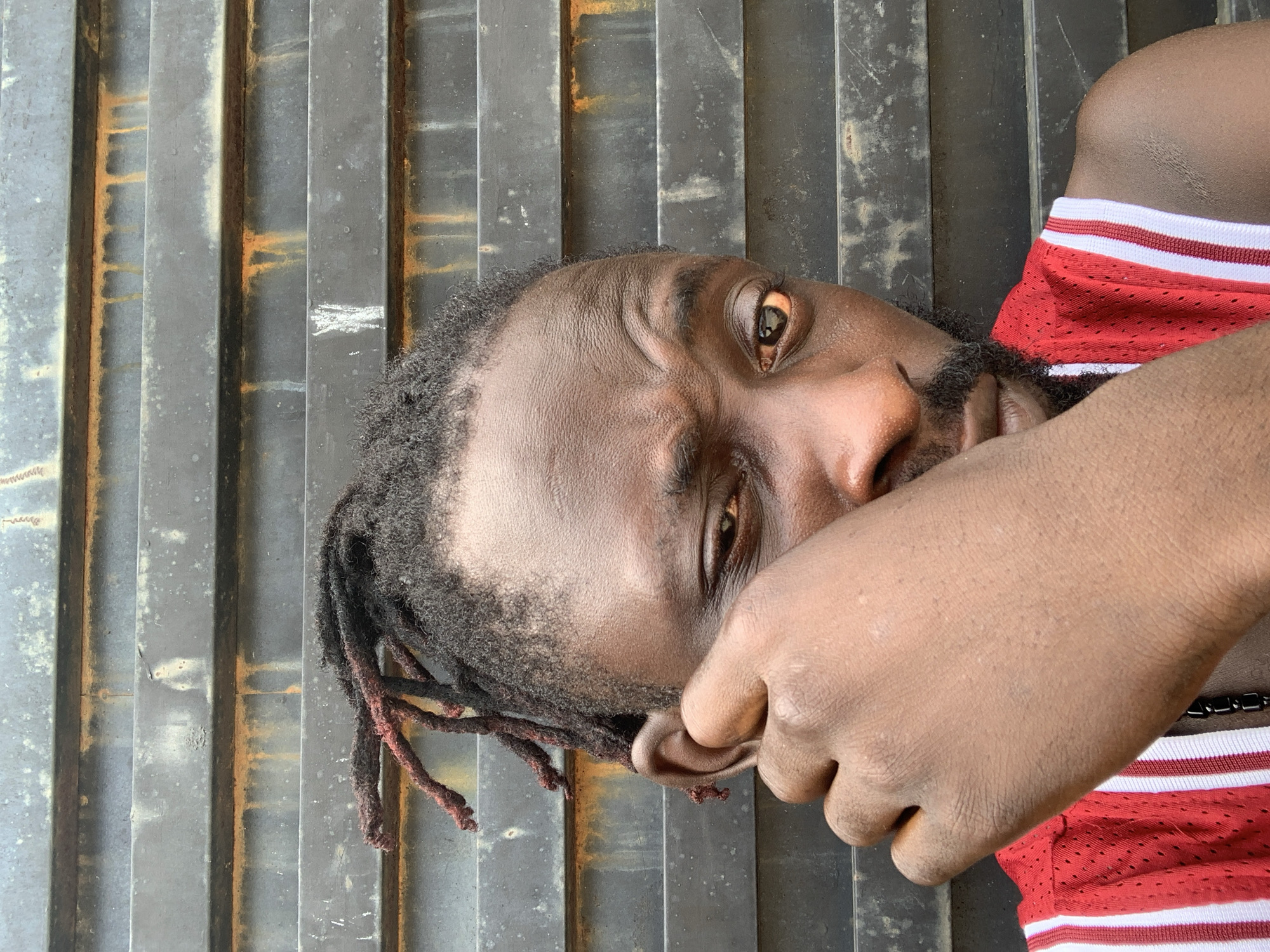 Young man in red athletic wear photographed in Lekki