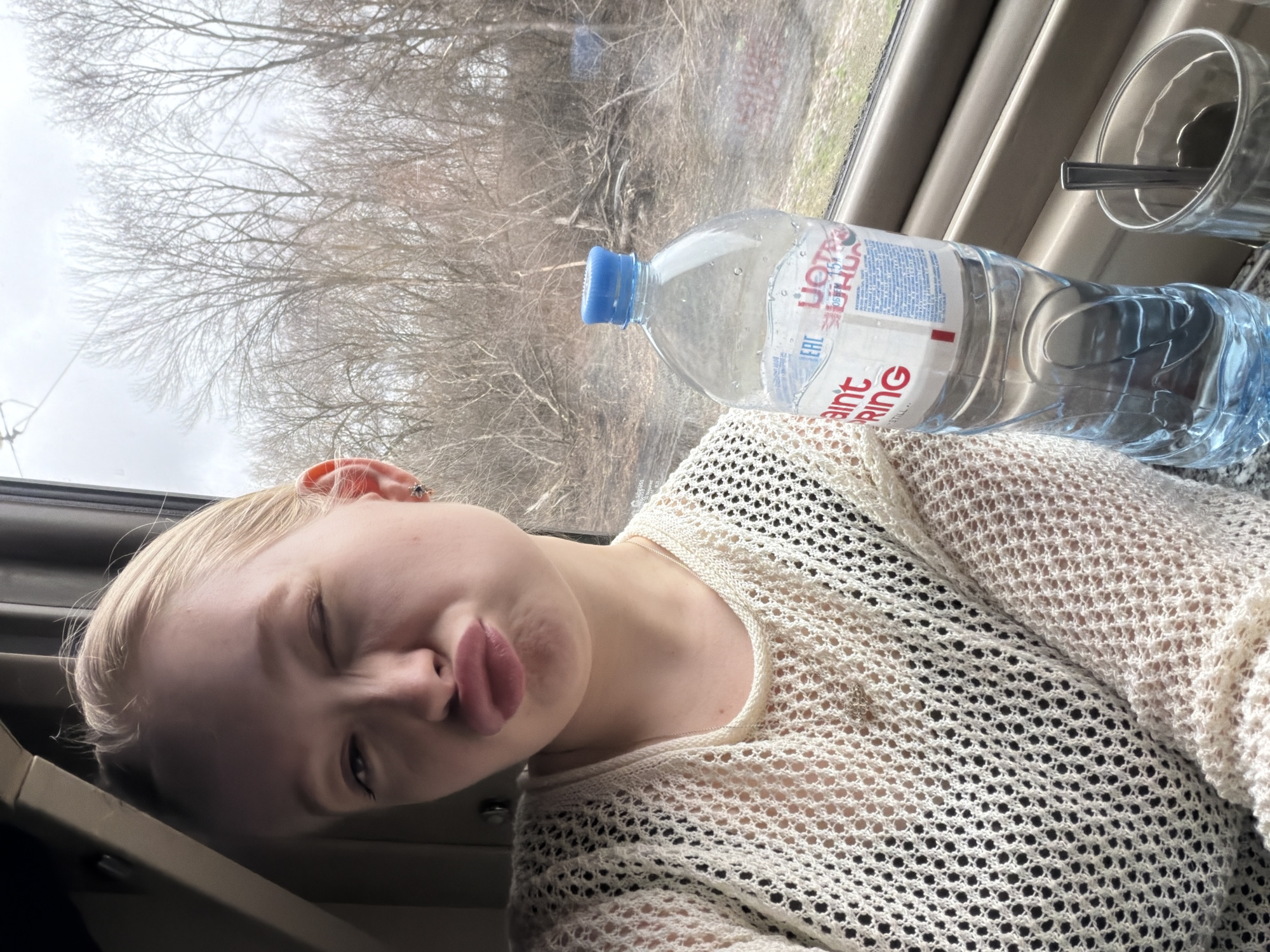 Woman poses playfully in train car in Russia