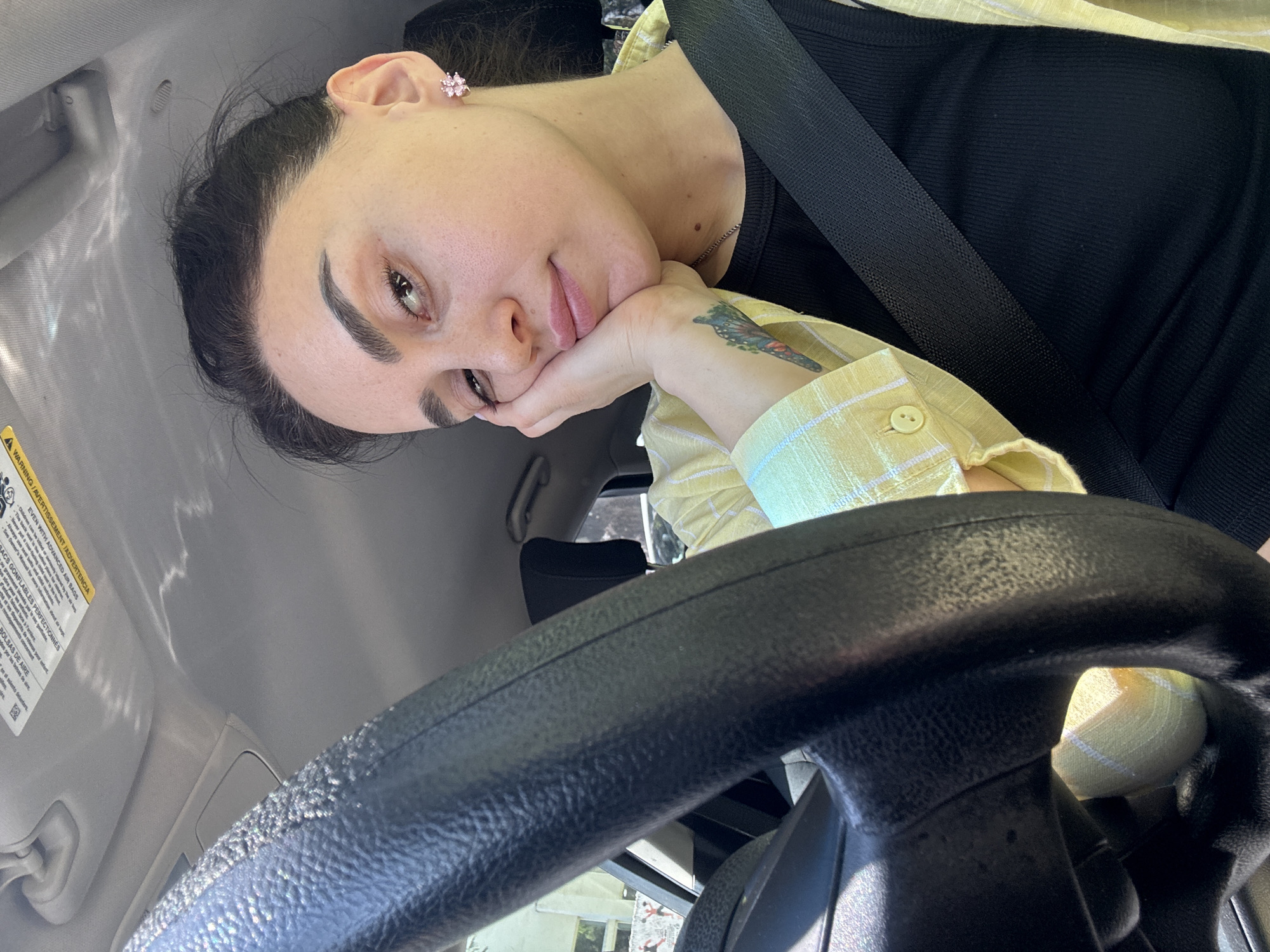 Woman photographed in car during morning hours in Tbilisi