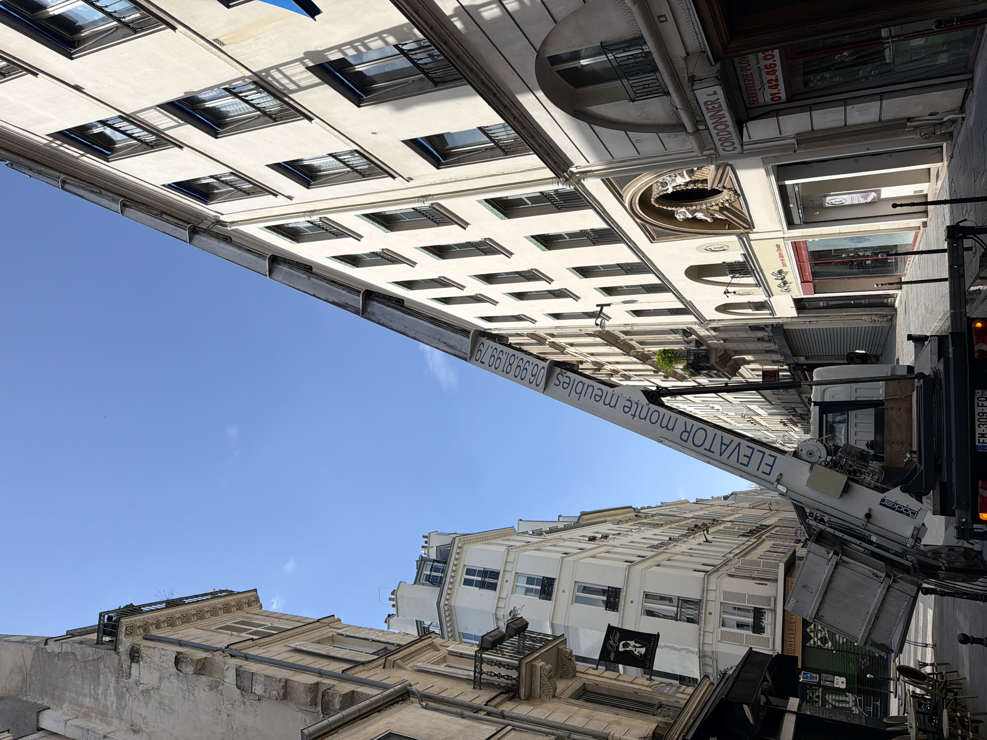 Clear skies frame Parisian building facades in afternoon scene