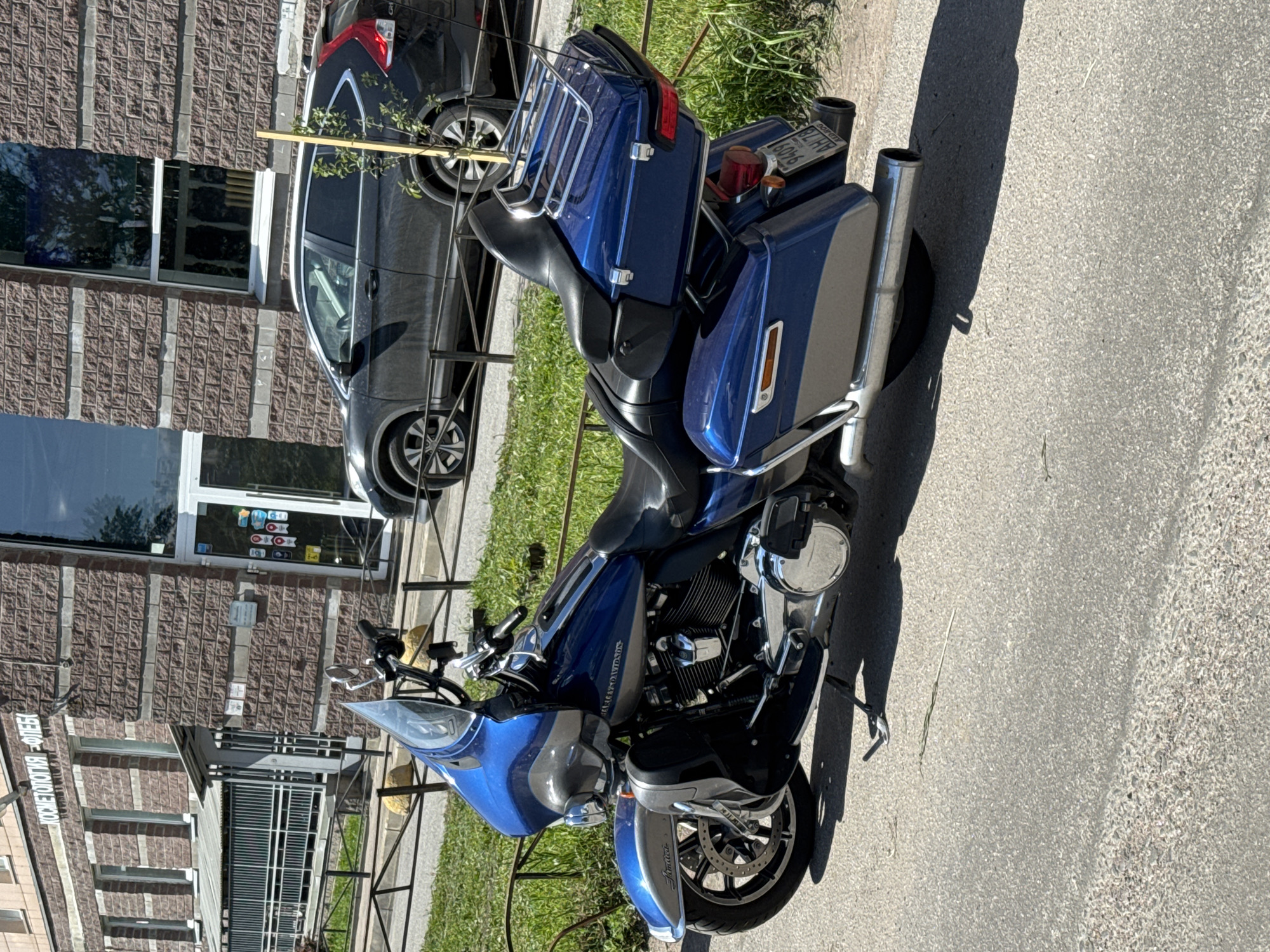 Harley-Davidson motorcycle parked on sunny street in Sinyavino, Russia