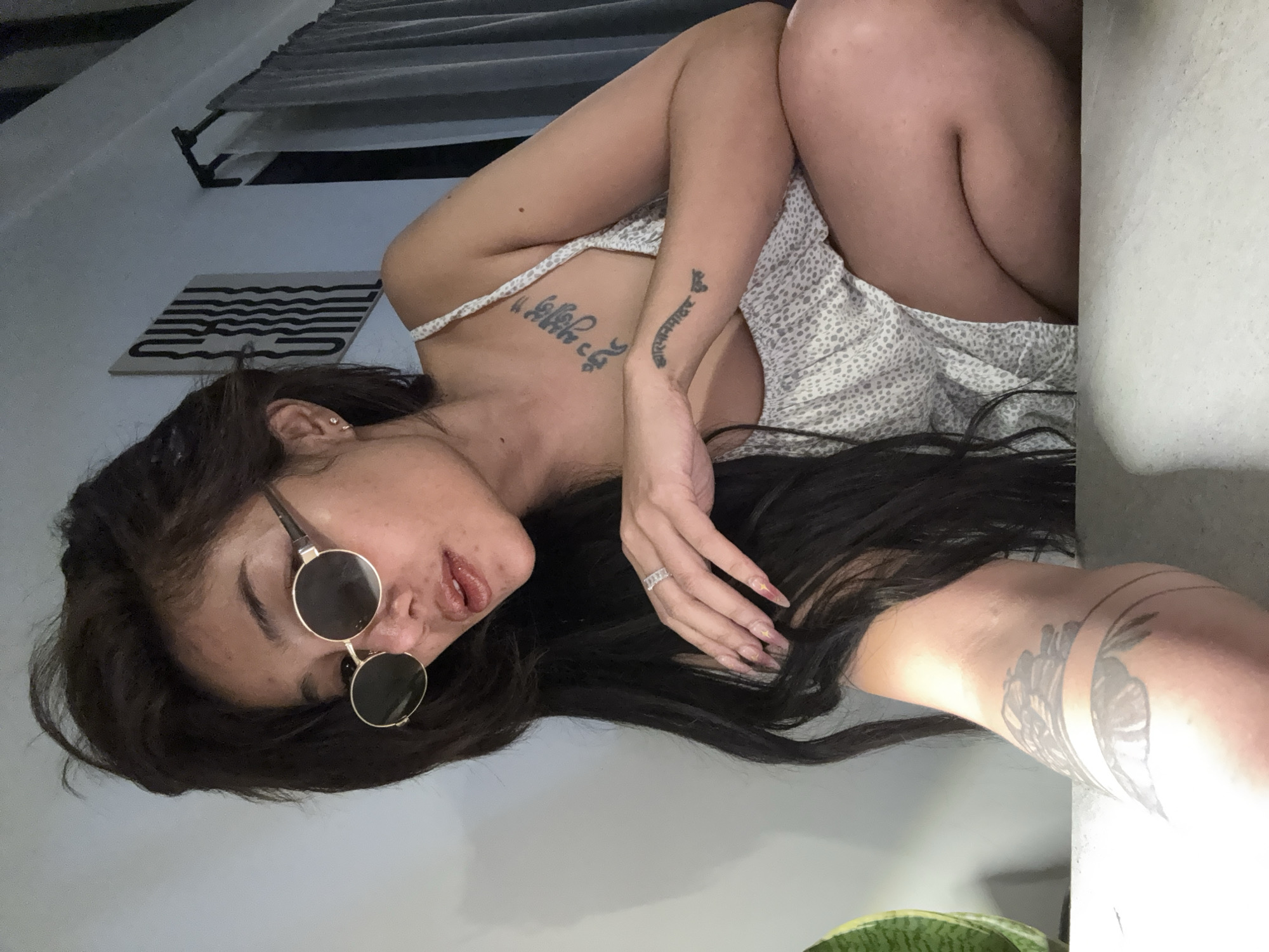 Woman in sunglasses photographed in multiple indoor poses