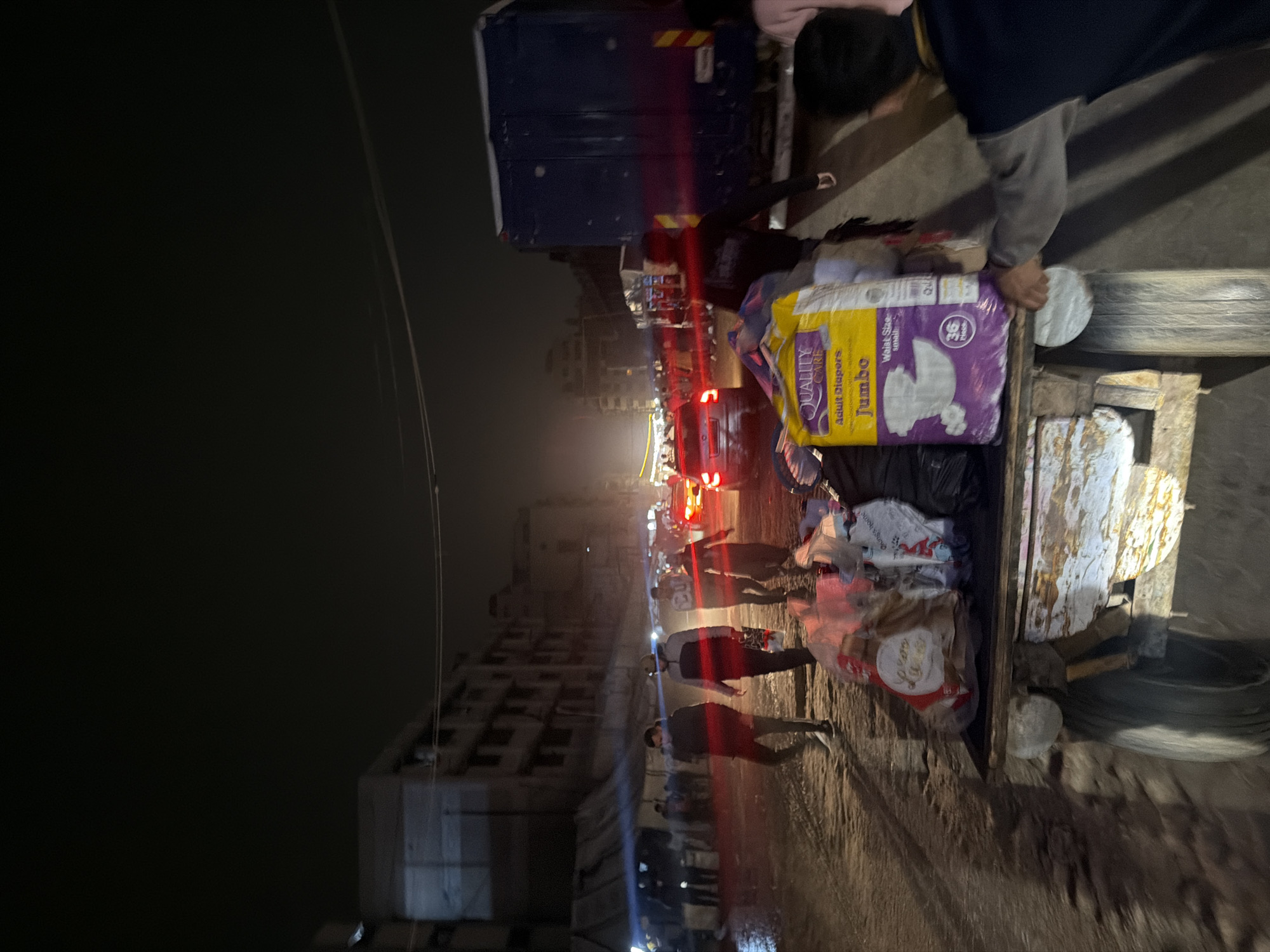 Night street activity in Gaza shows supply delivery, balloon vendor
