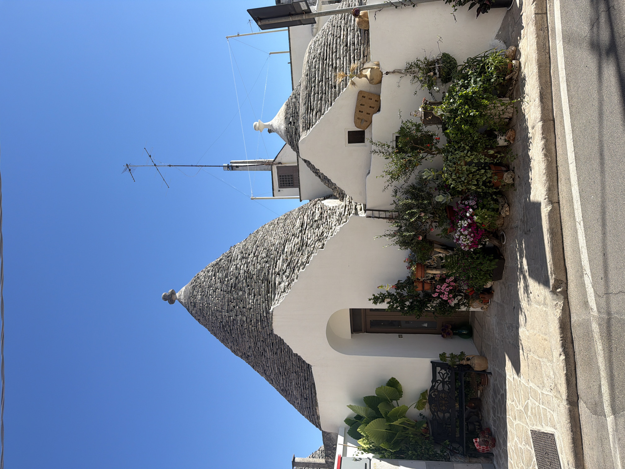 Alberobello's trulli streets and church square on a sunny afternoon