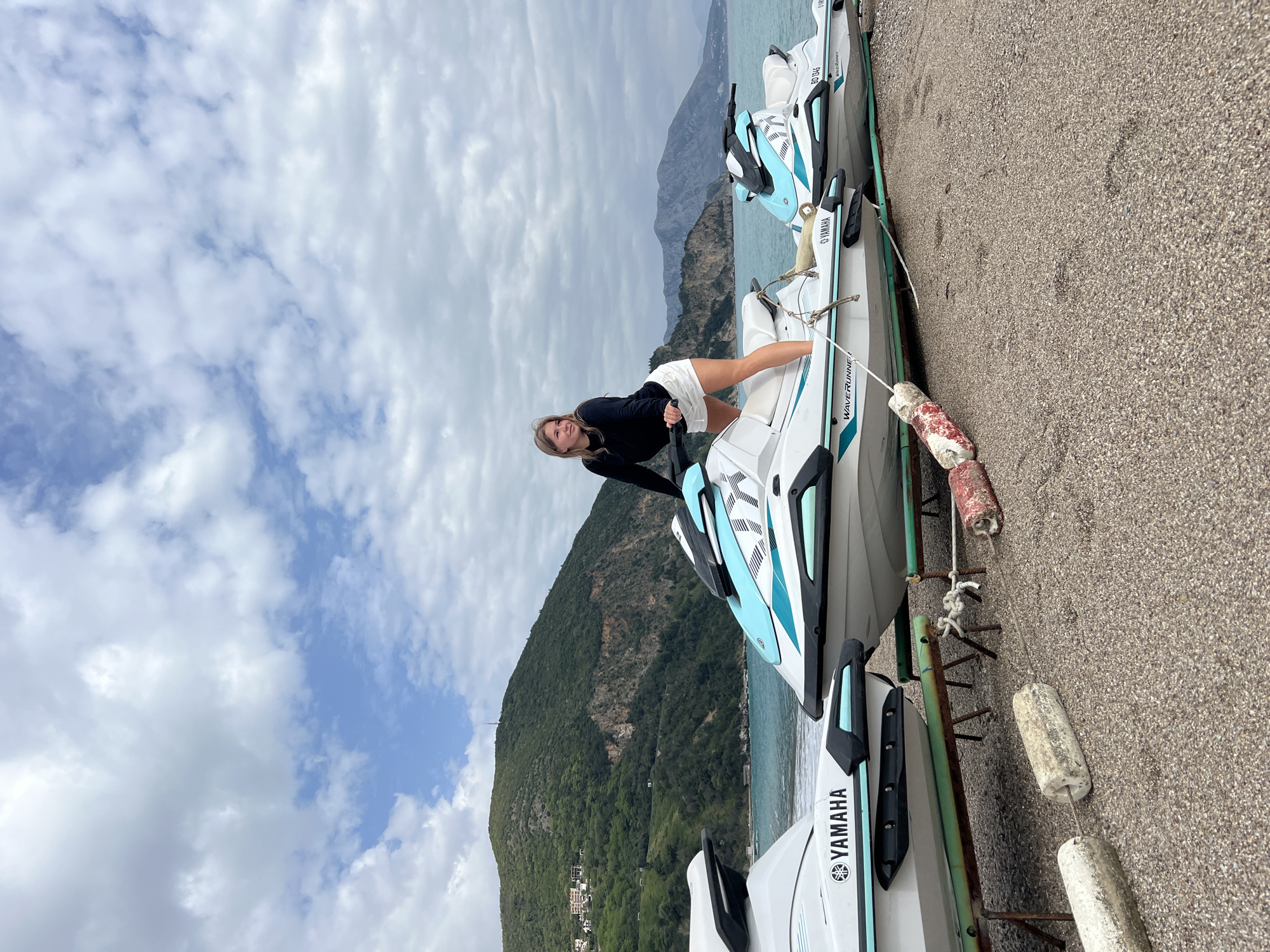 Woman poses with WaveRunner on Montenegro waterfront