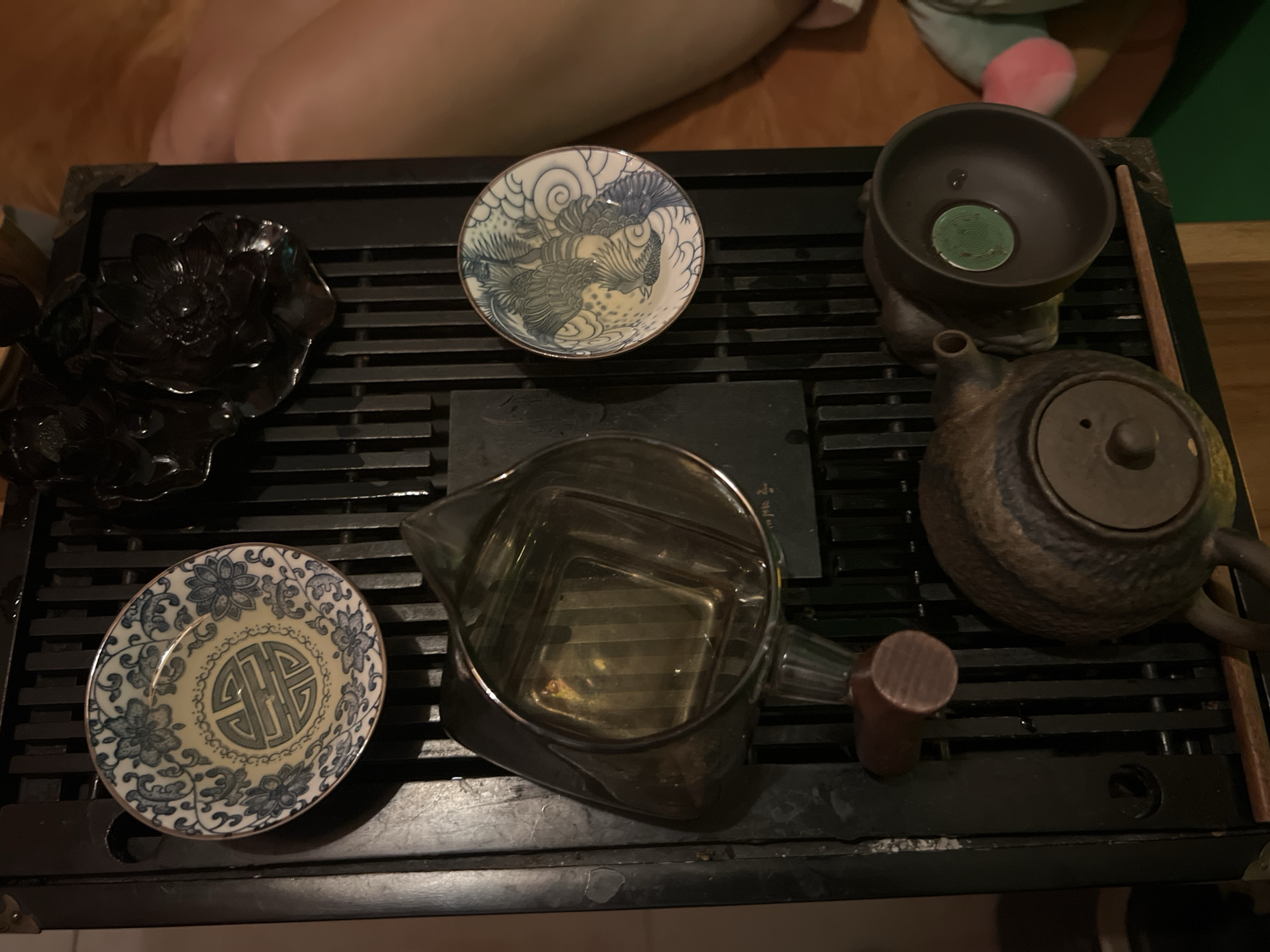 Tea ceremony documented with ornate ceramics and glass pitcher