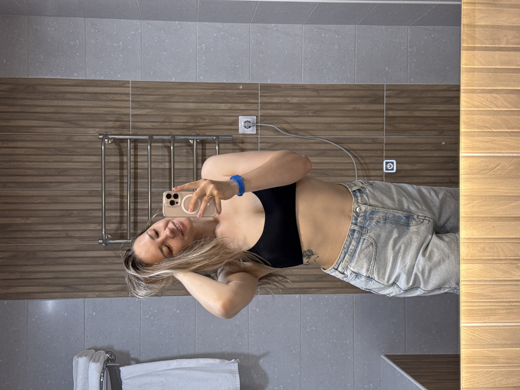 Woman takes mirror selfie in Nebug bathroom