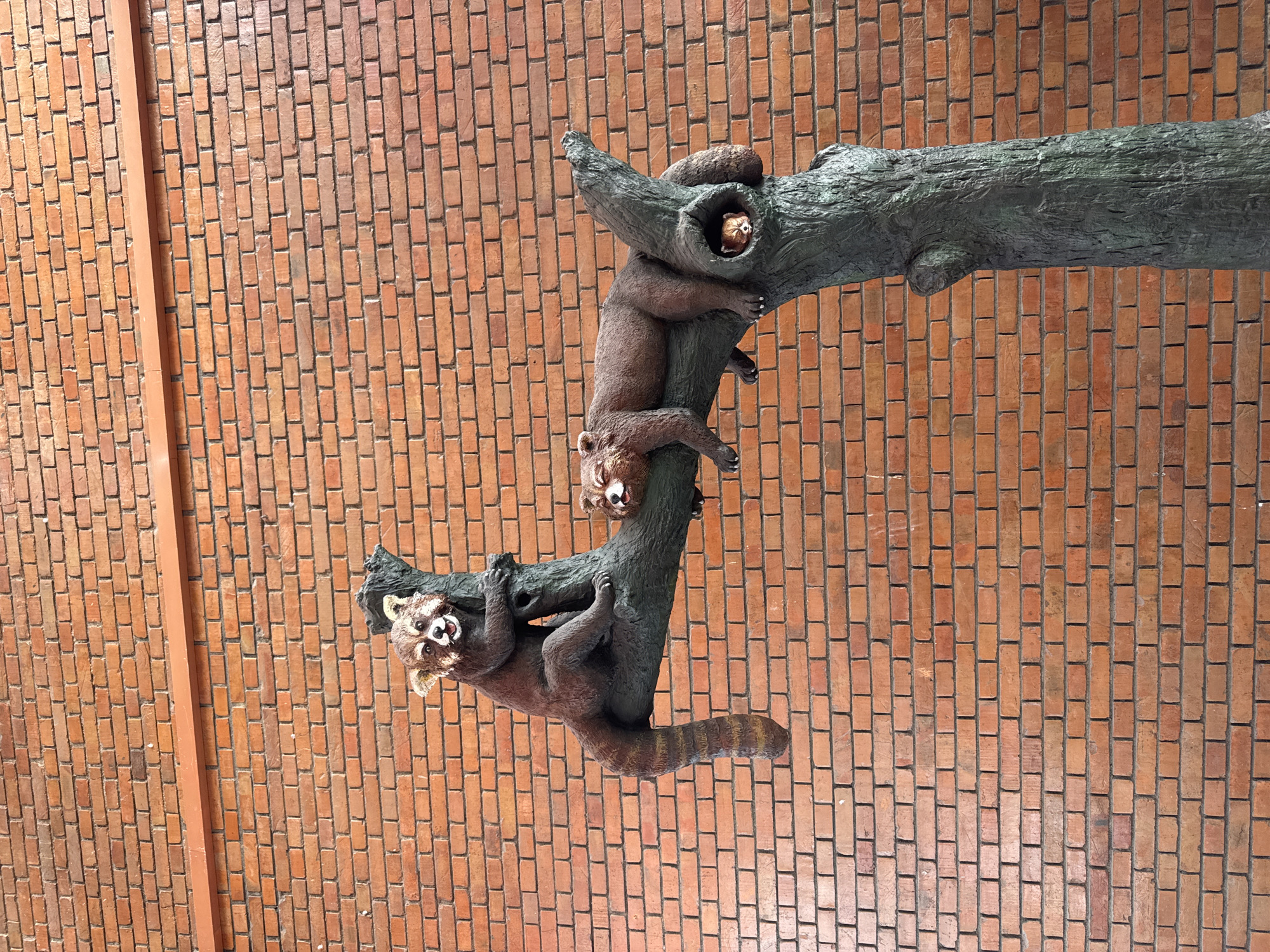 Red panda sculpture spotted on brick wall in Kathmandu