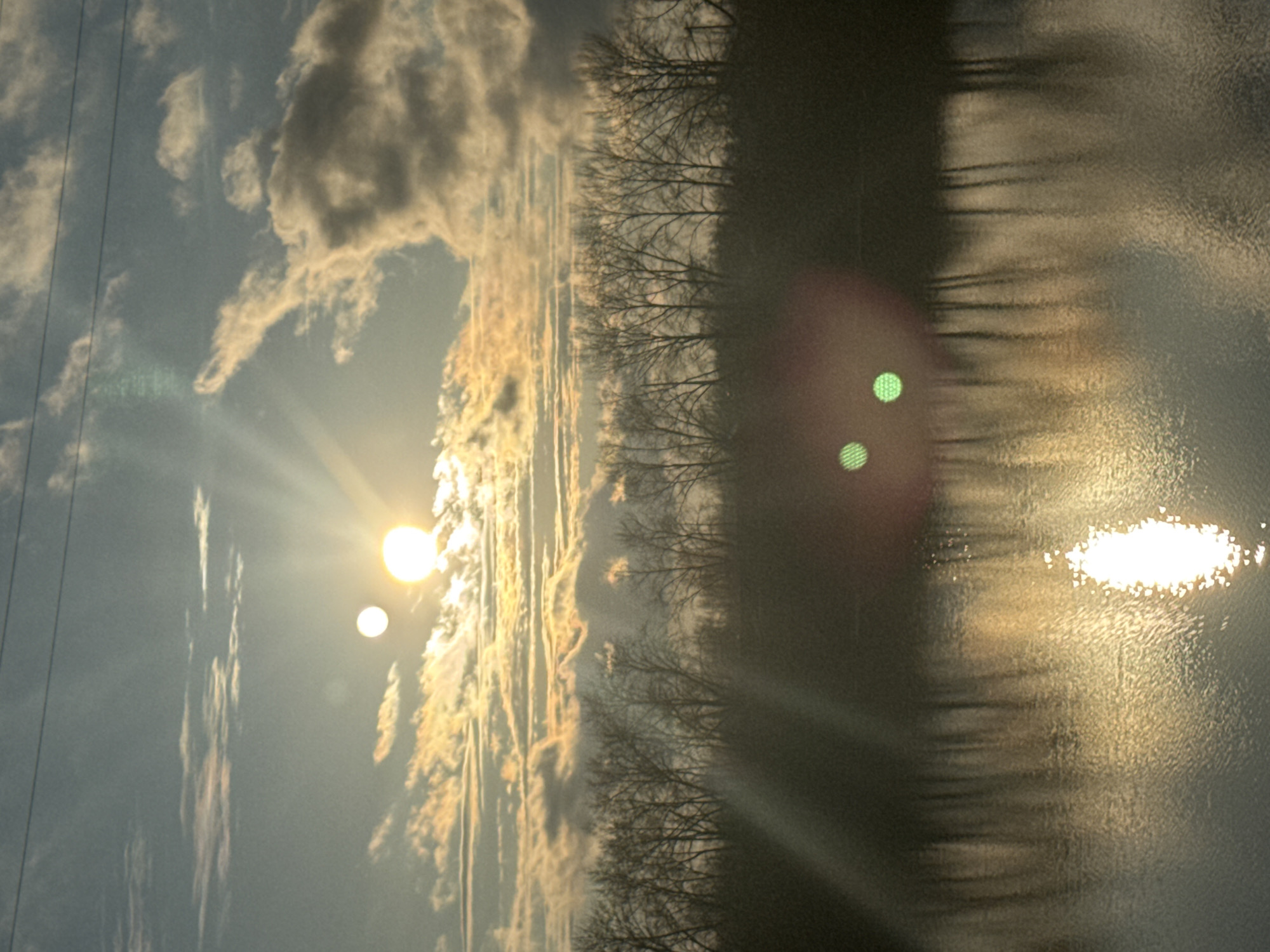Woman captures sunset selfies by water in Chaikovsky, Russia