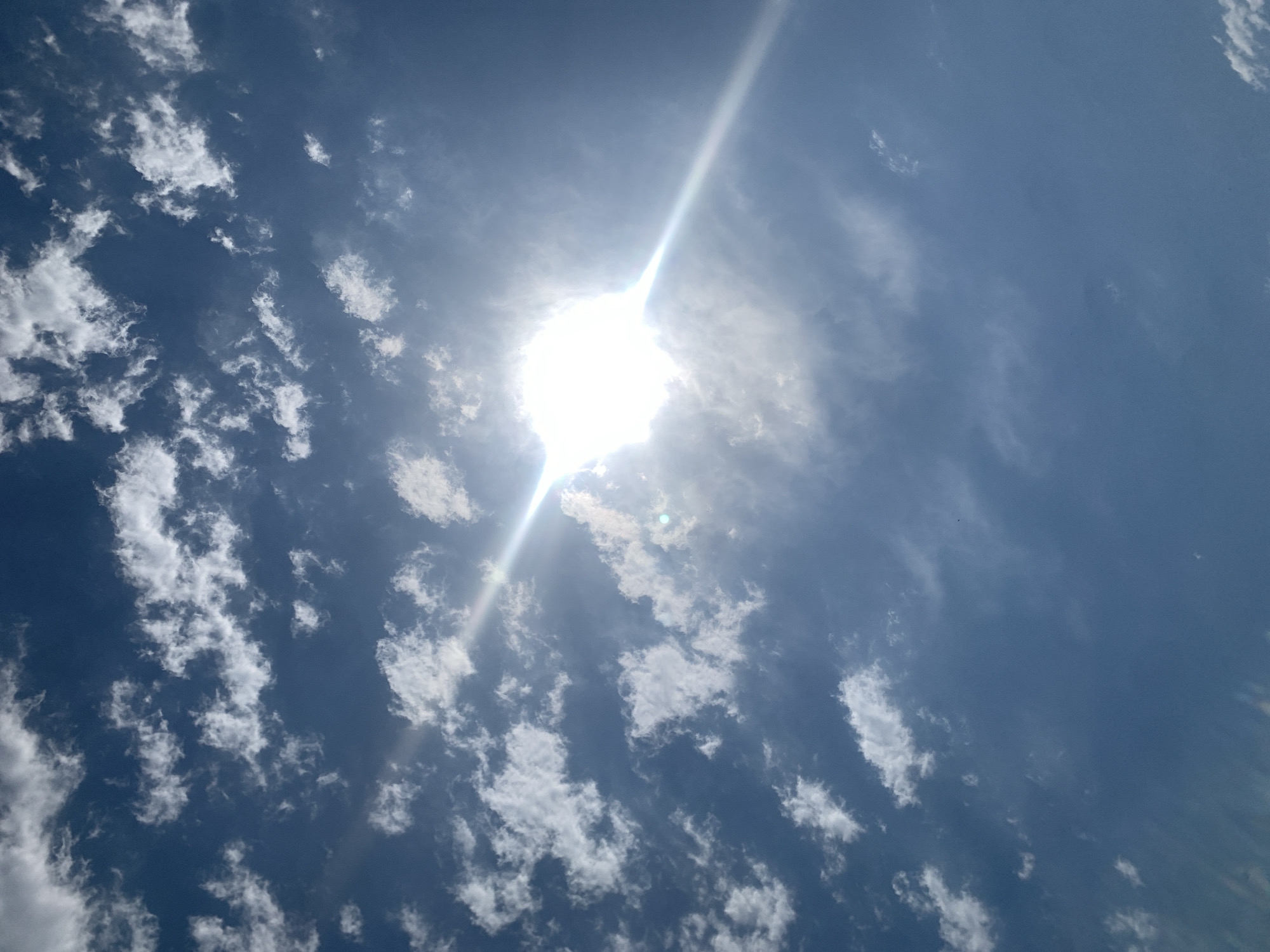 Bright summer sky over Azerbaijan, lens flare and clouds