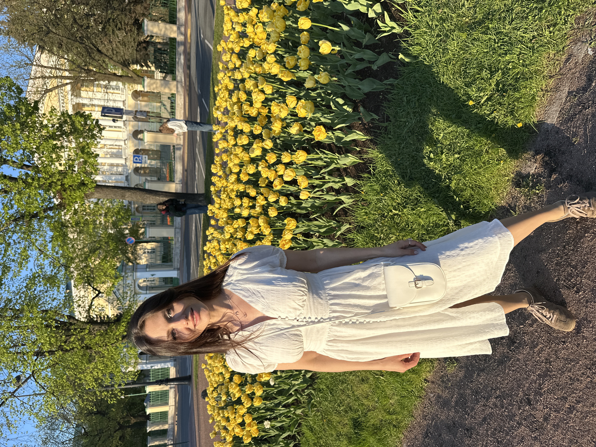 Woman enjoys spring tulips in Saint Petersburg park