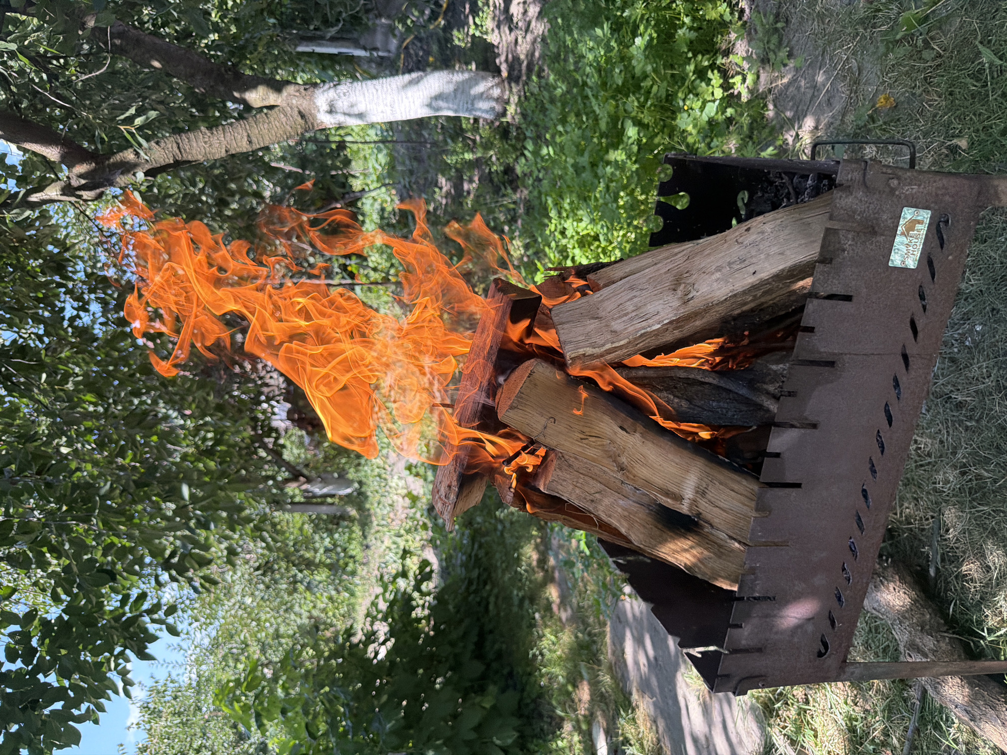 Wood fire burning in a metal grill, Polonne backyard